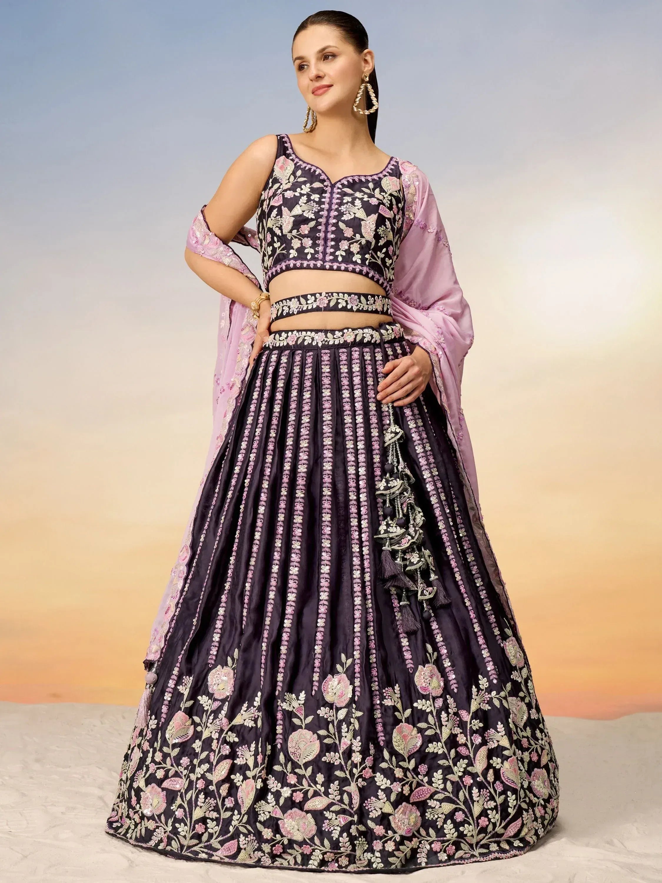 Elegant purple lehenga choli with floral embroidery and pink dupatta, perfect for Indian weddings and festivals.