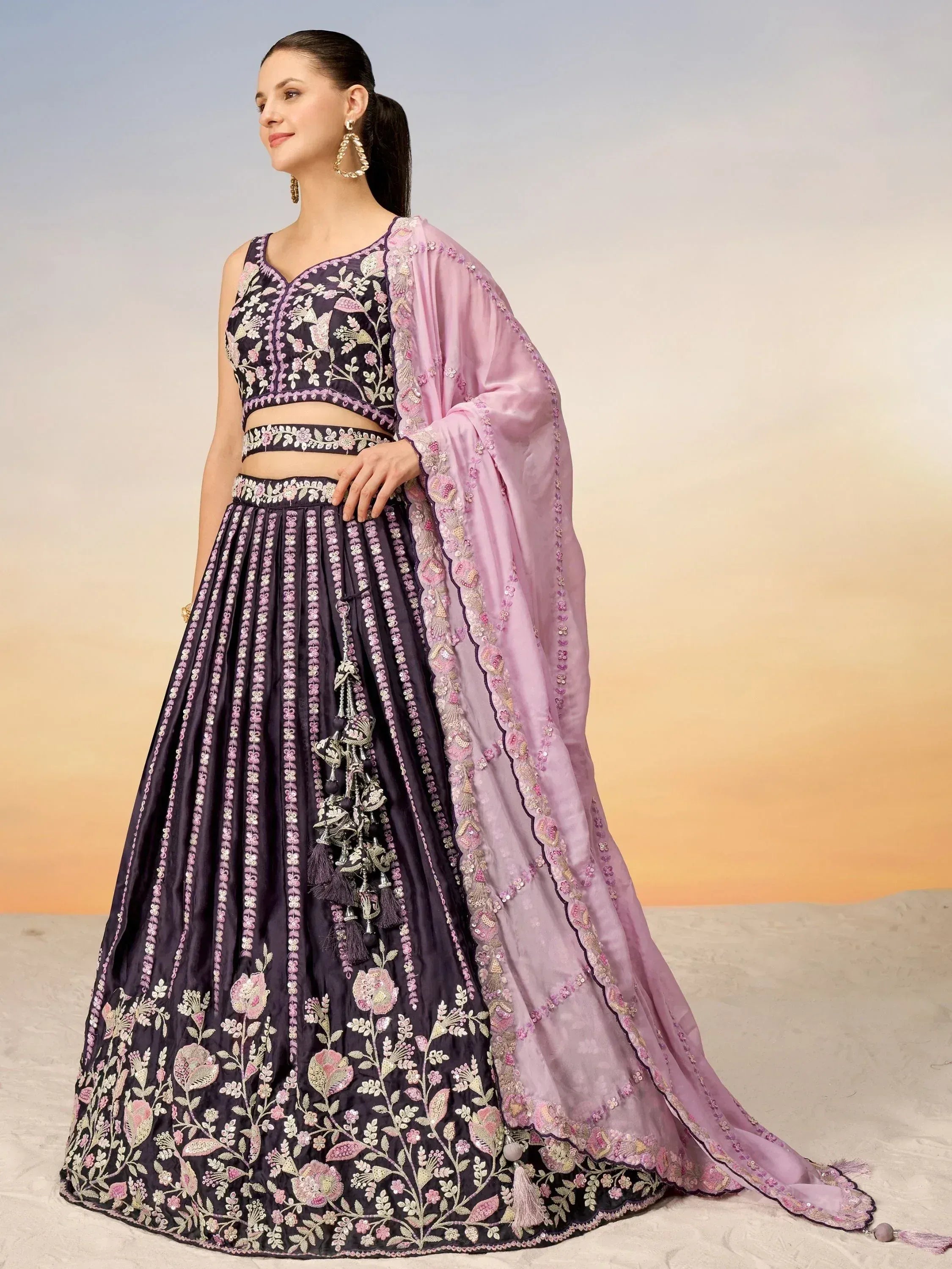 Elegant purple lehenga choli with floral embroidery and pink dupatta, perfect for Indian ethnic occasions.