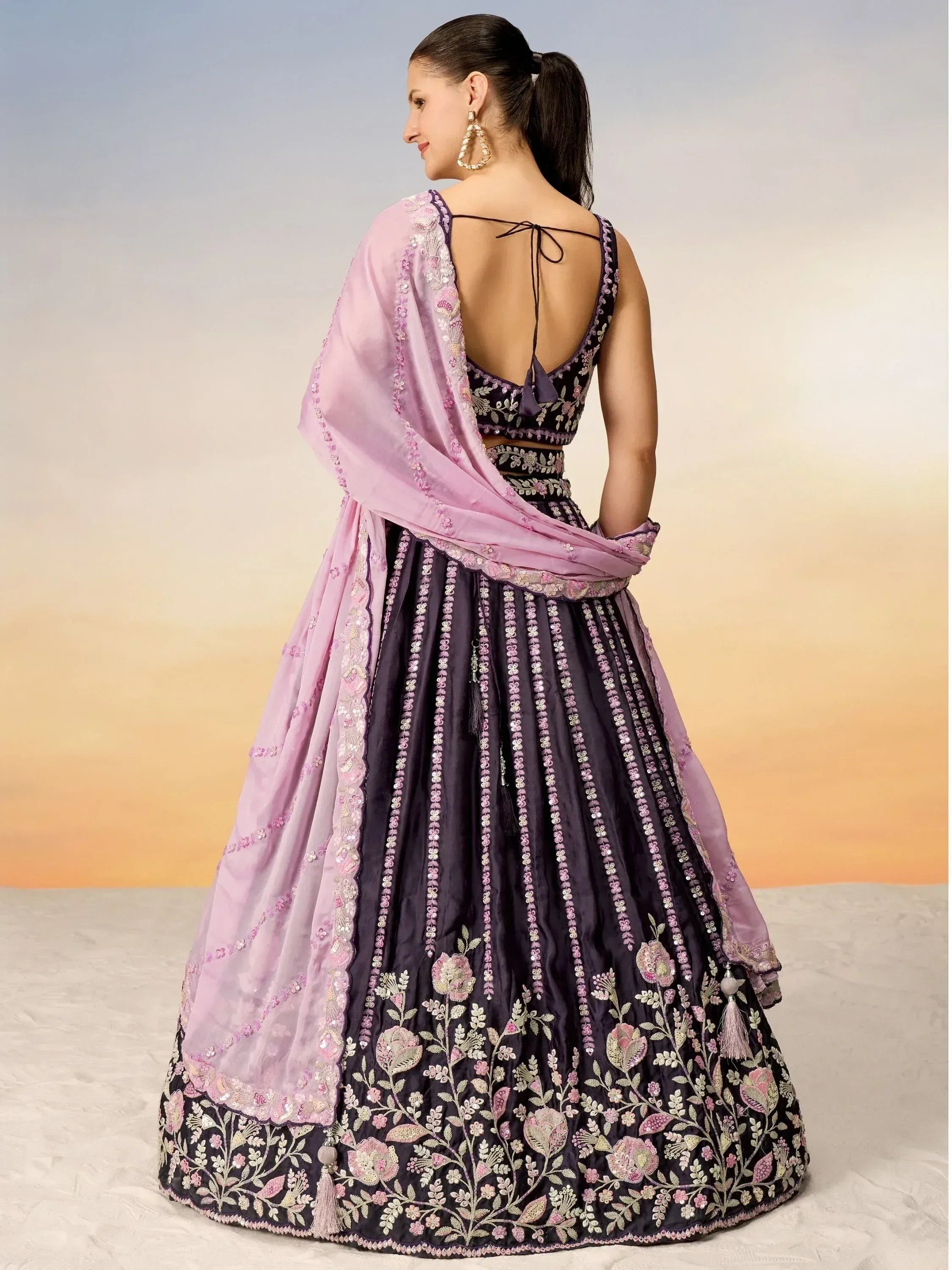 Elegant purple lehenga choli with floral embroidery and pink dupatta, perfect for Indian ethnic wear occasions.