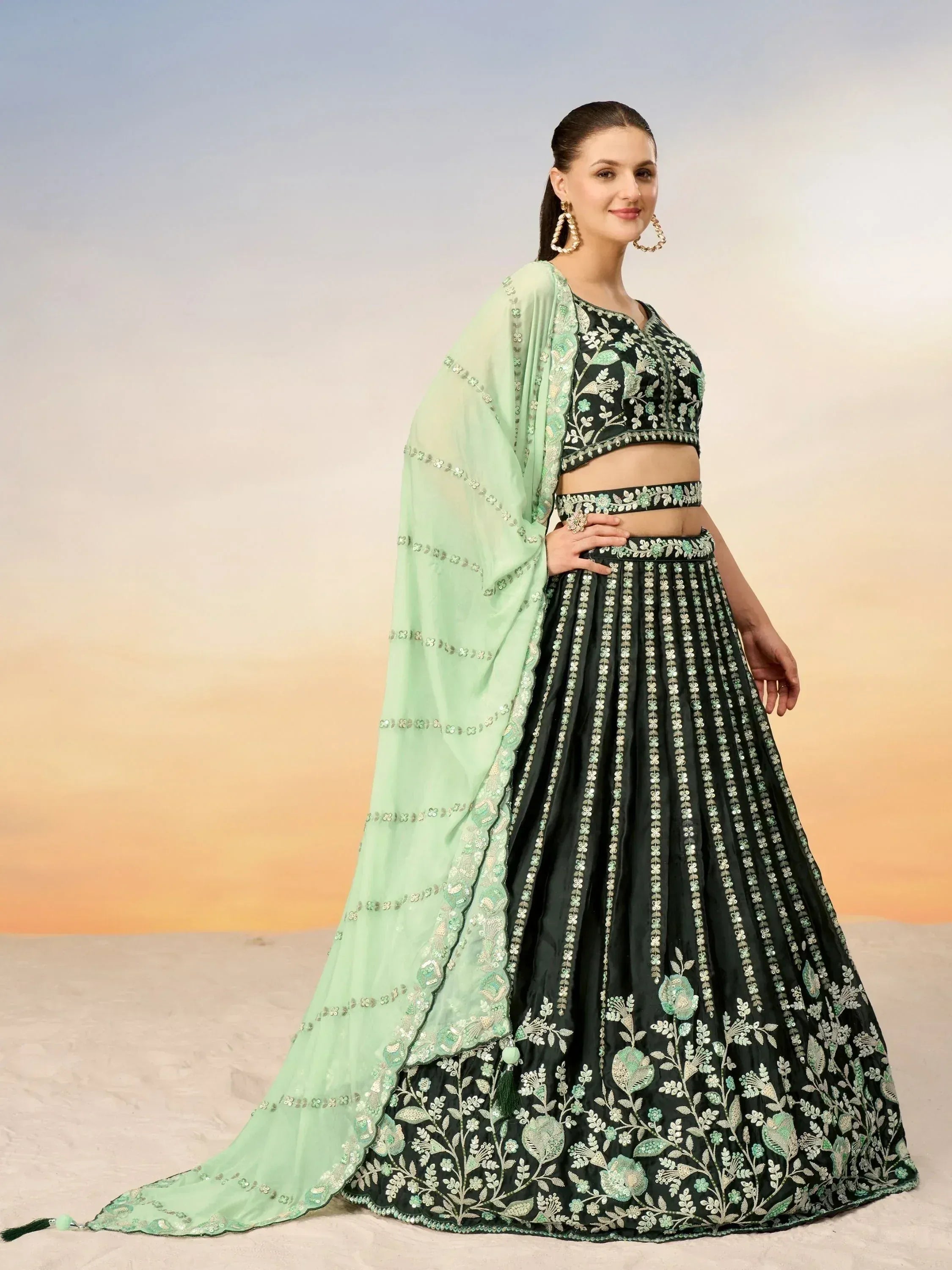 Black and mint green embroidered lehenga choli with floral design, perfect for Indian ethnic wear occasions.