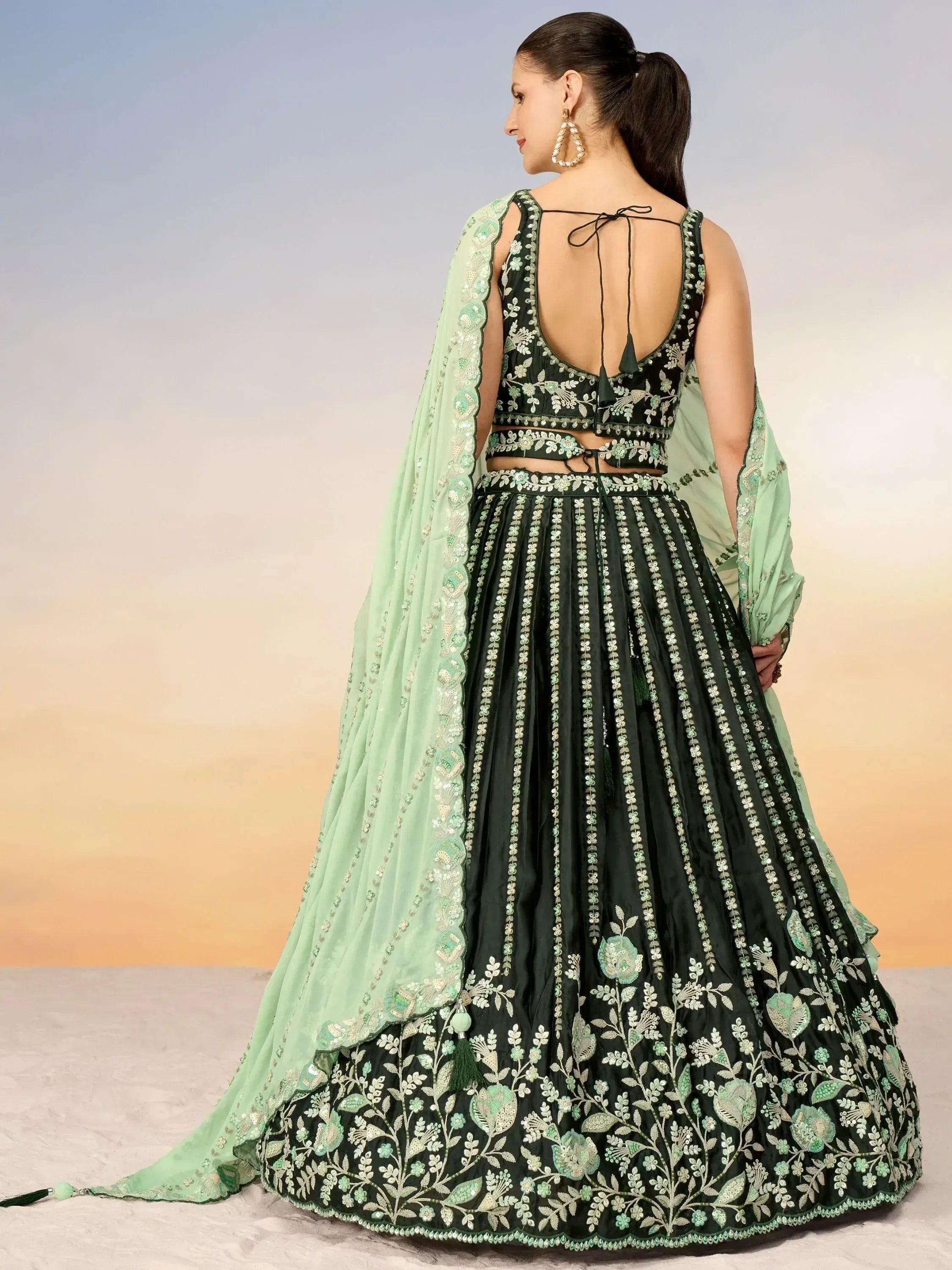 Green embroidered lehenga choli with floral design and matching dupatta, perfect for Indian ethnic occasions.