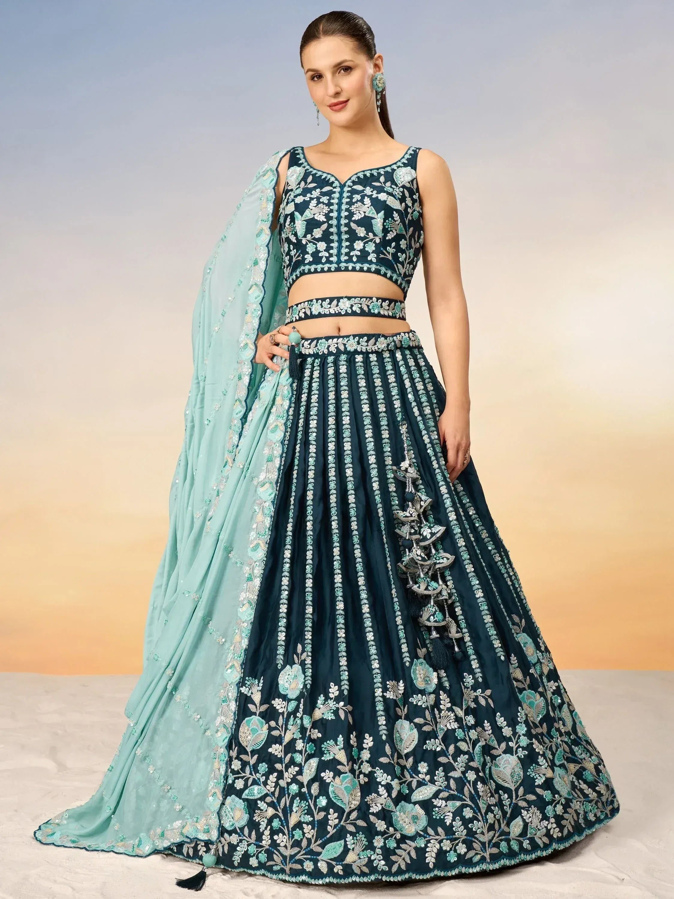 Teal embroidered lehenga choli with floral motifs and matching dupatta, perfect for Indian ethnic occasions.
