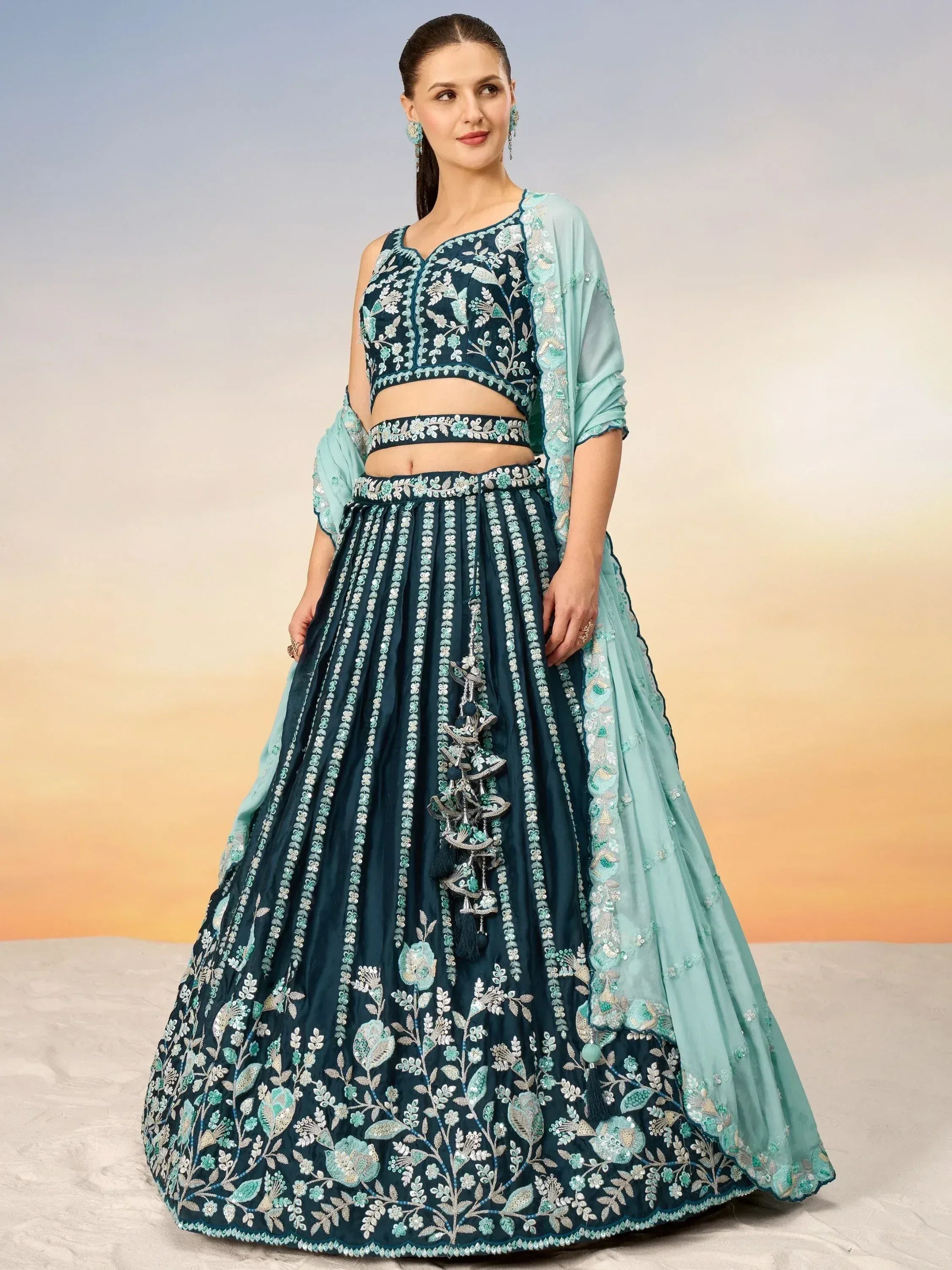Teal embroidered lehenga choli with floral motifs and matching dupatta, perfect for Indian ethnic wear.