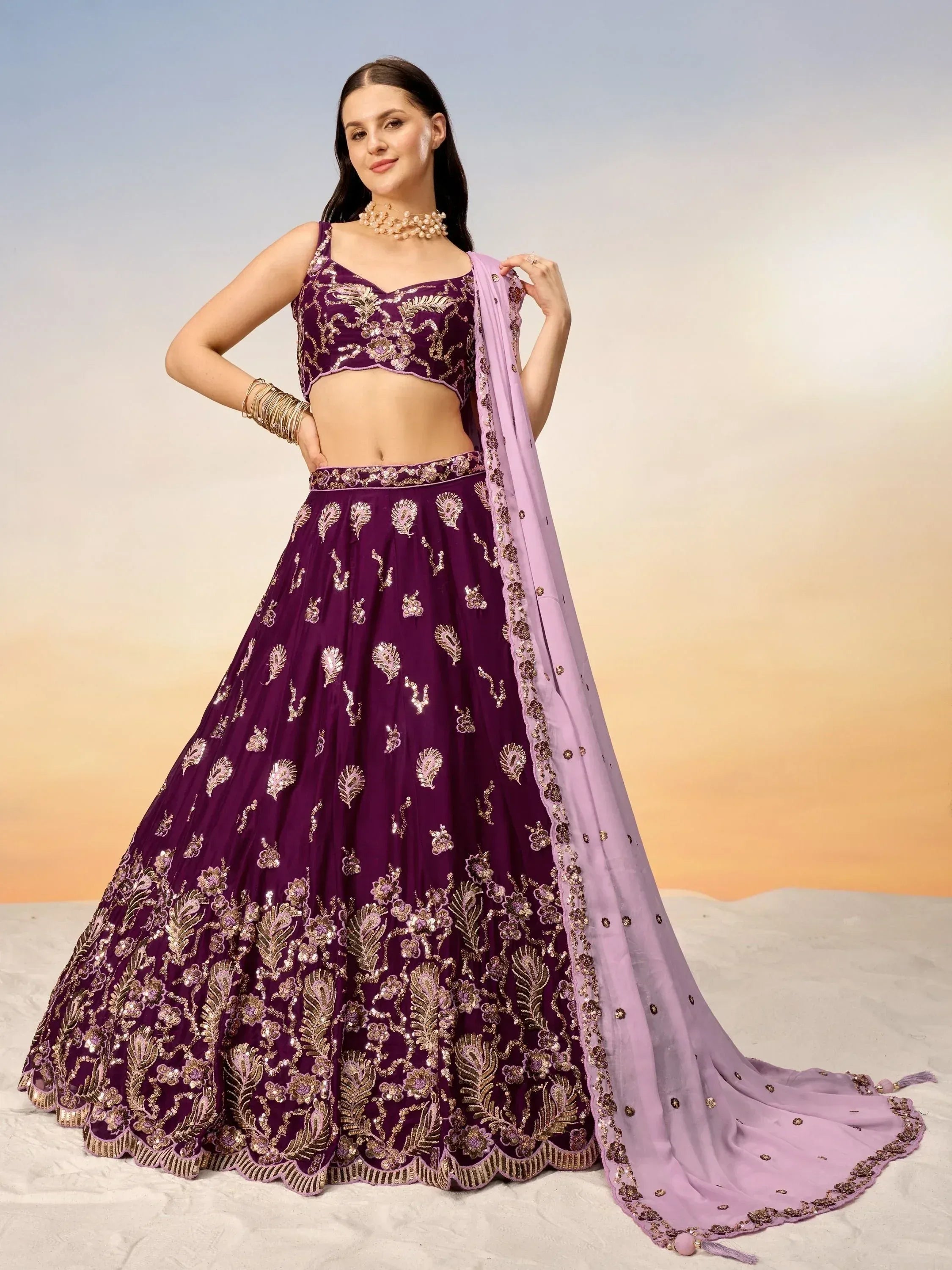 Purple embroidered lehenga choli with gold detailing and matching dupatta, ideal for Indian ethnic wear occasions.