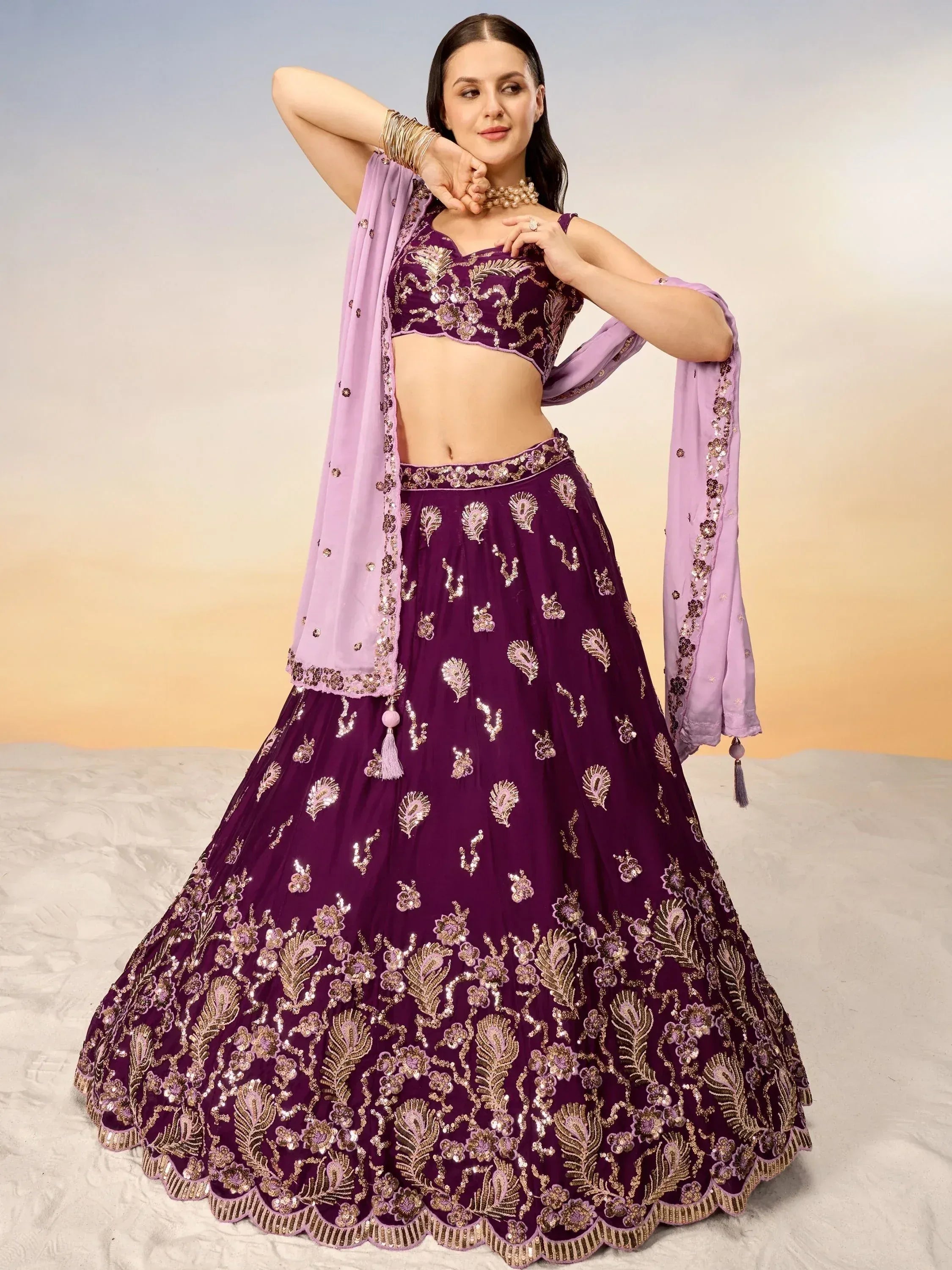 Purple embroidered lehenga choli with gold floral work and matching dupatta, perfect for Indian ethnic occasions.