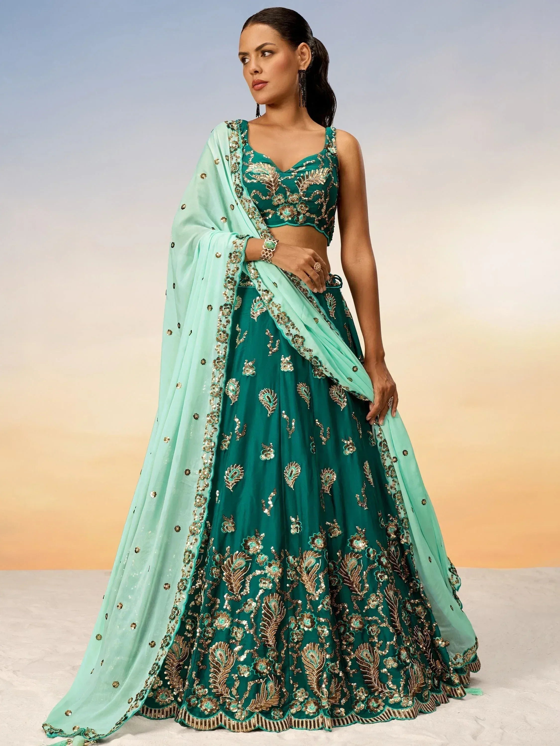 Emerald green embroidered lehenga choli with gold detailing and mint dupatta for Indian ethnic wear