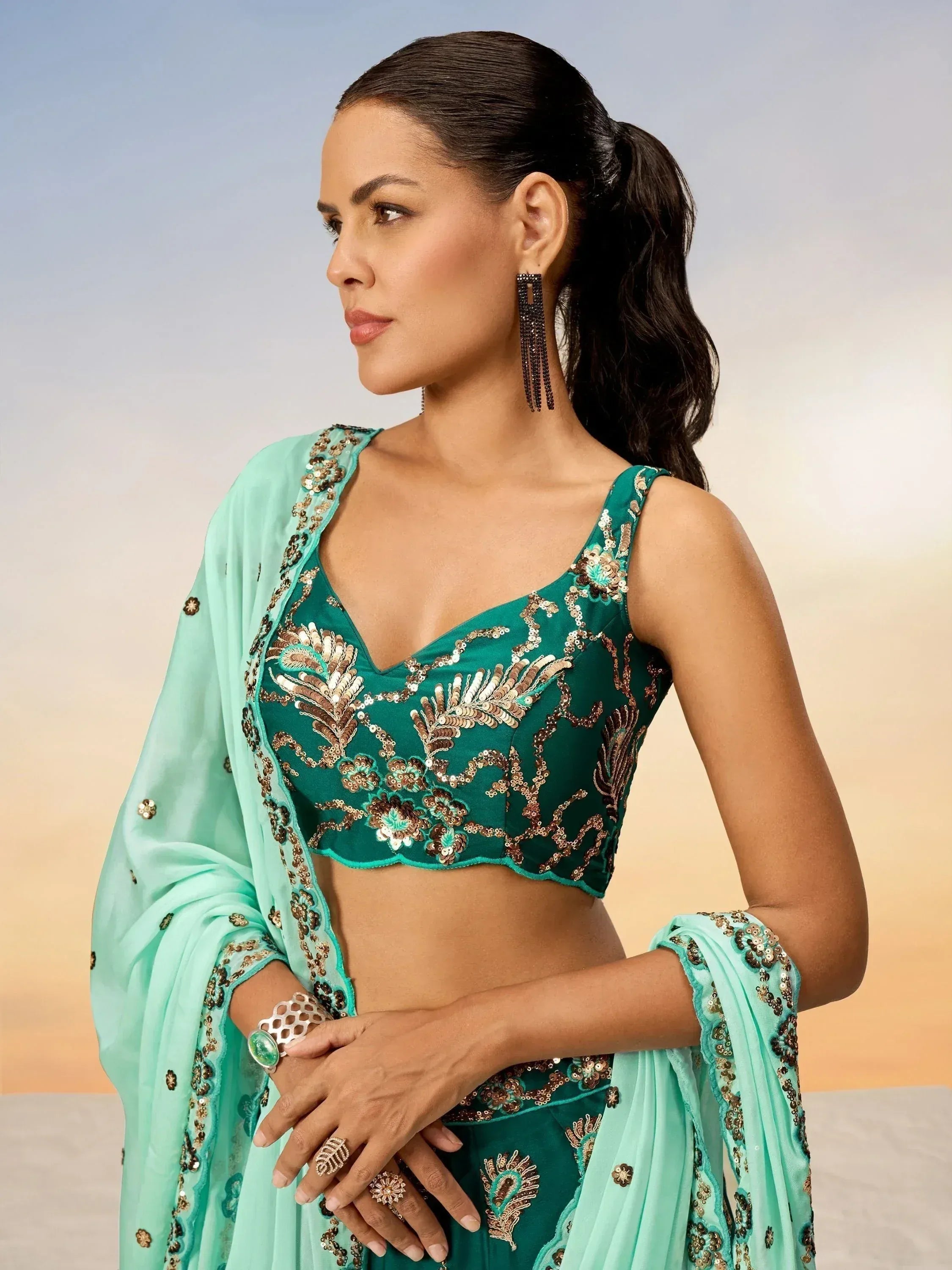 Emerald green embroidered lehenga choli with sequin work and matching dupatta, perfect for Indian ethnic occasions.