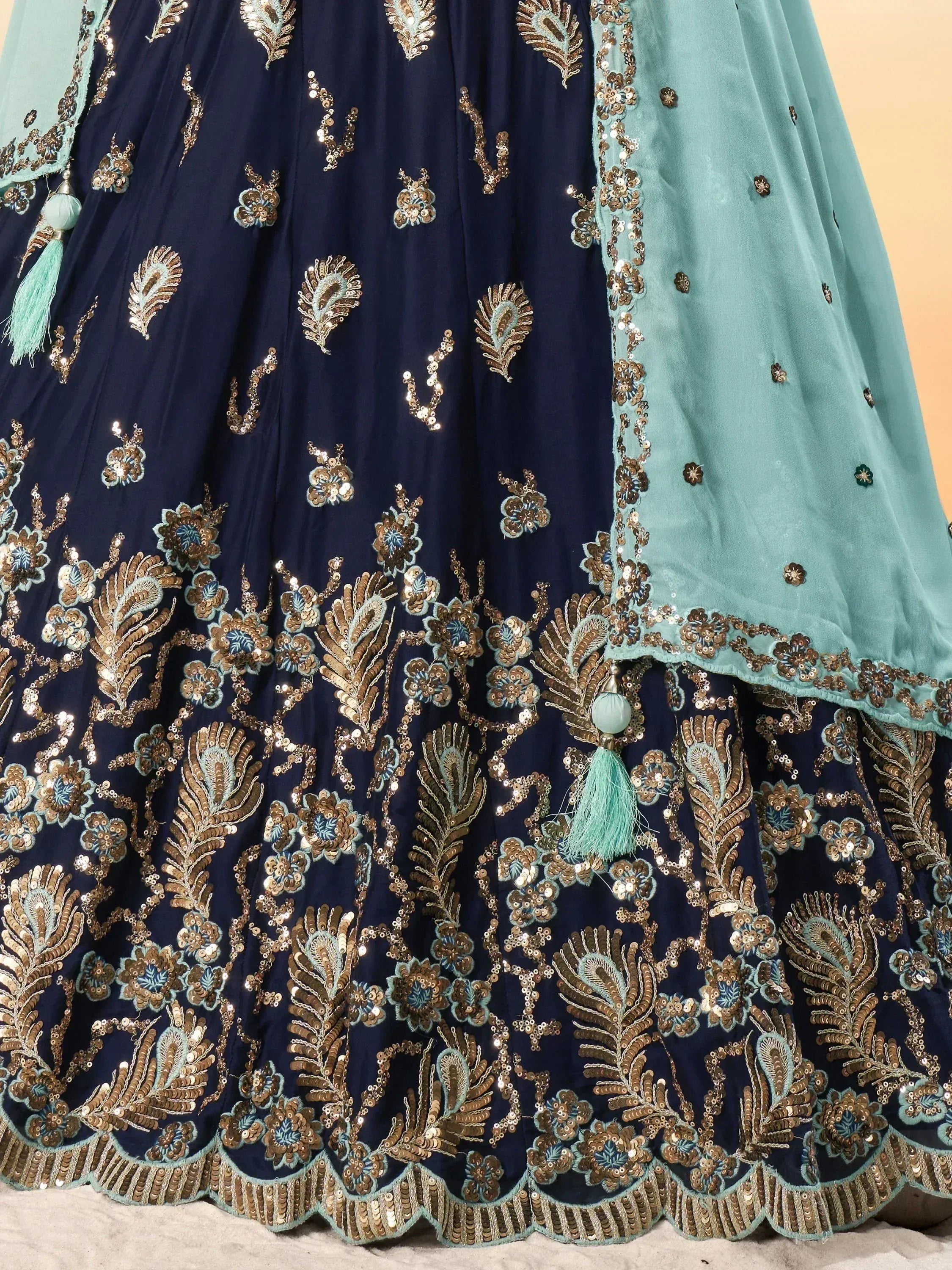 Navy blue and mint green designer lehenga with gold sequin embroidery and tassels