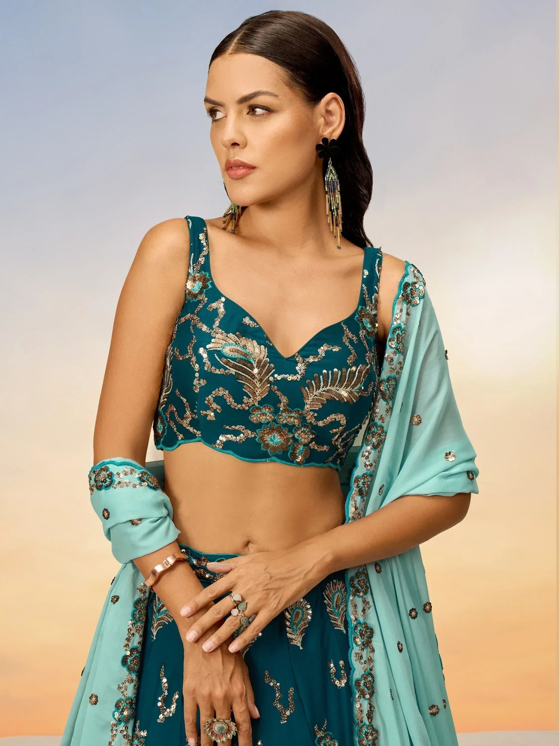 Teal embroidered lehenga choli with sequin work, perfect for Indian ethnic wear and festive occasions.