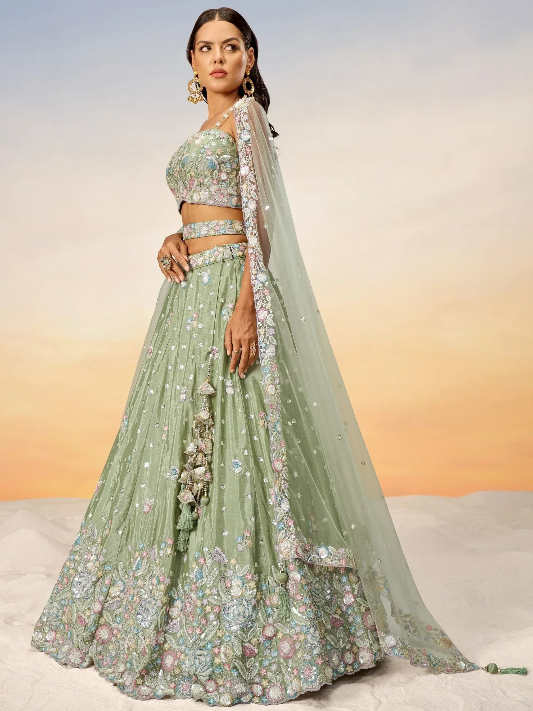 Mint green embroidered lehenga choli with floral motifs and sheer dupatta, perfect for Indian ethnic occasions.