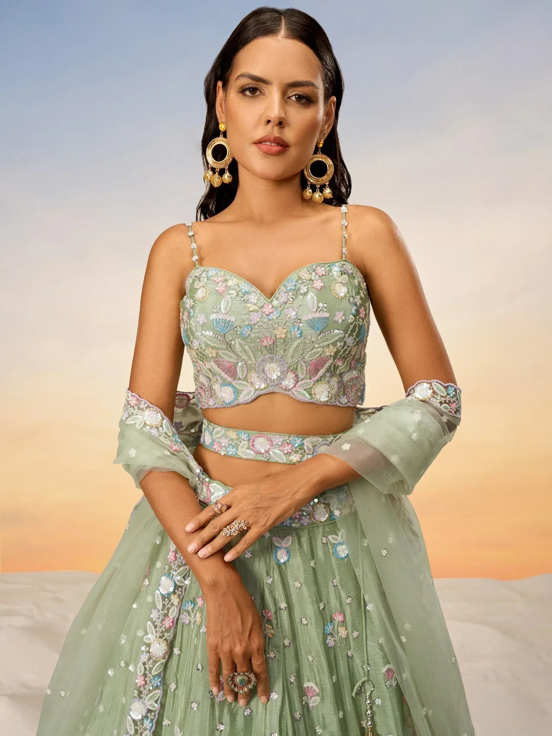 Mint green embroidered lehenga choli with floral detailing, perfect for Indian ethnic wear occasions.