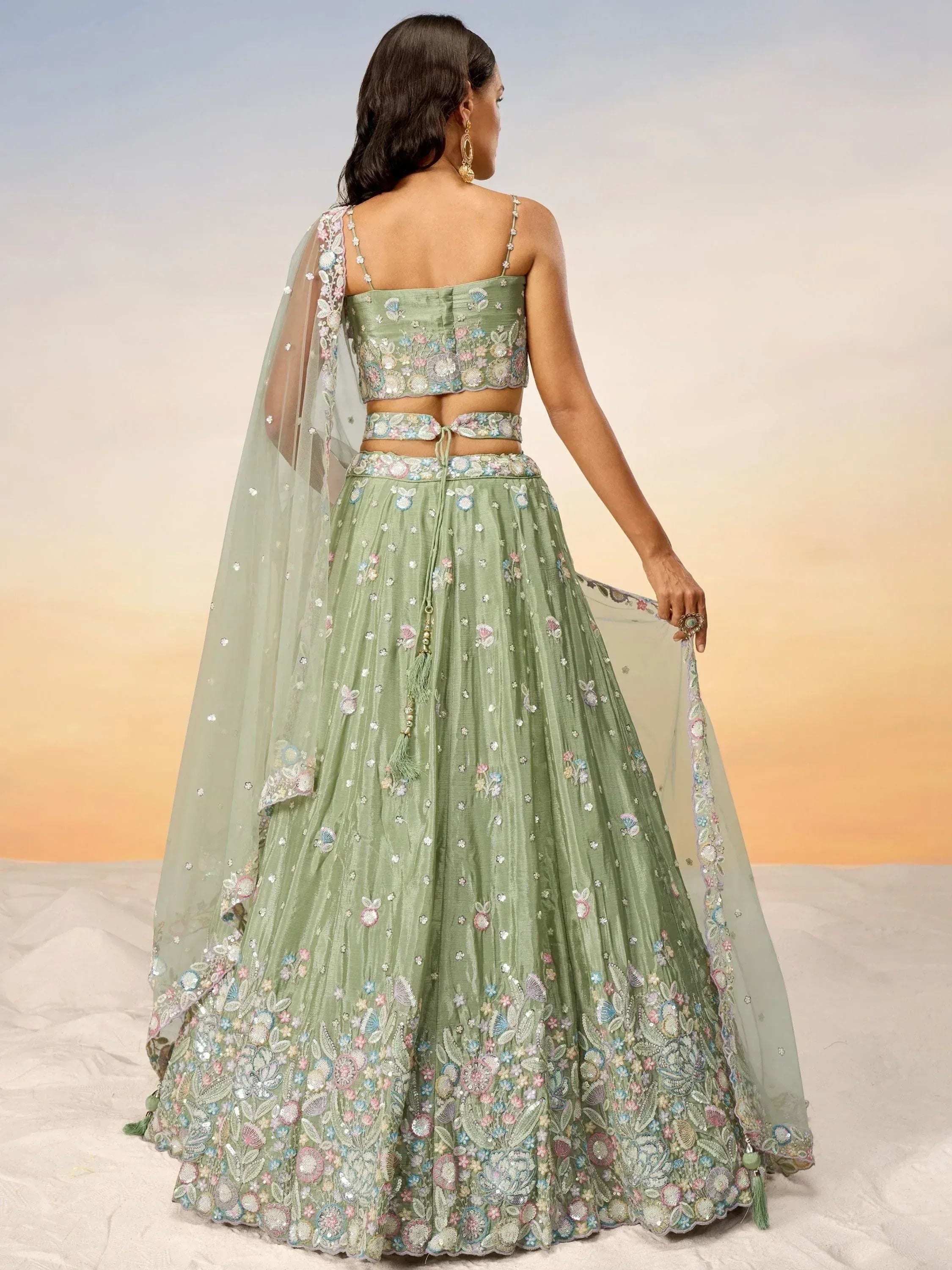 Mint green embroidered lehenga choli with floral motifs and sheer dupatta, perfect for Indian ethnic occasions.