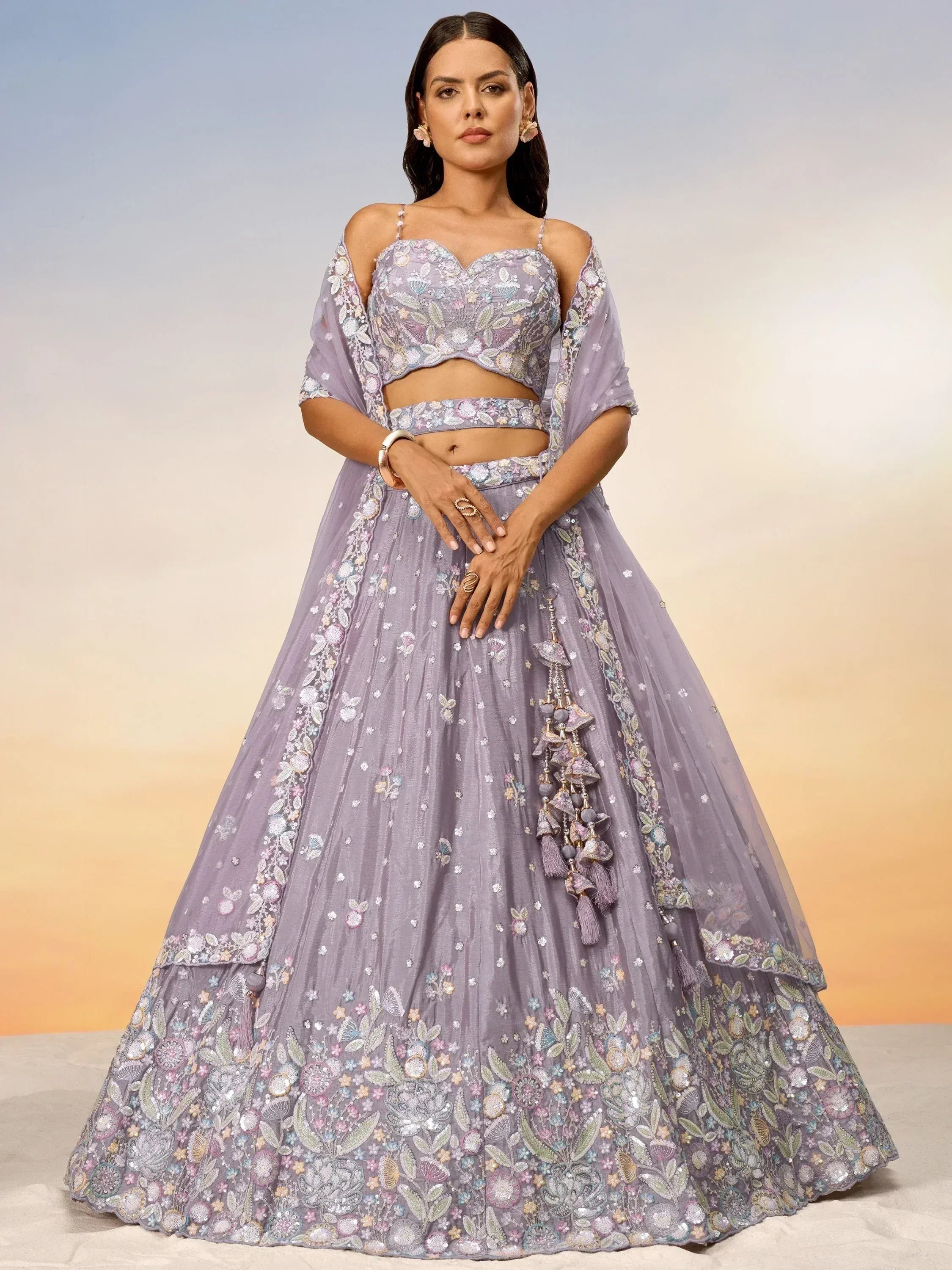 Lavender embroidered lehenga choli with floral motifs and tassels, perfect for Indian ethnic occasions
