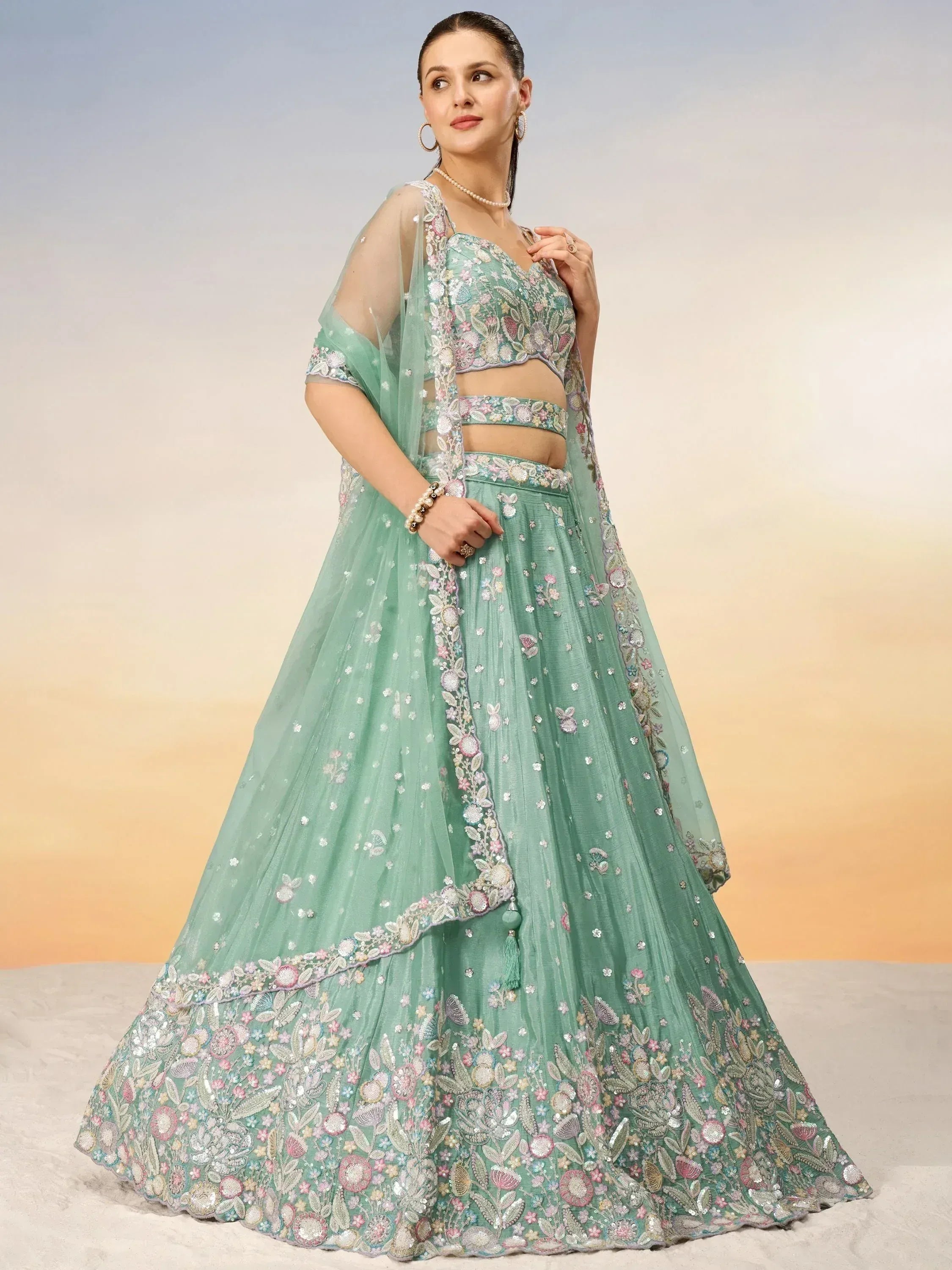 Mint green embroidered lehenga choli with floral embellishments, perfect for Indian ethnic occasions