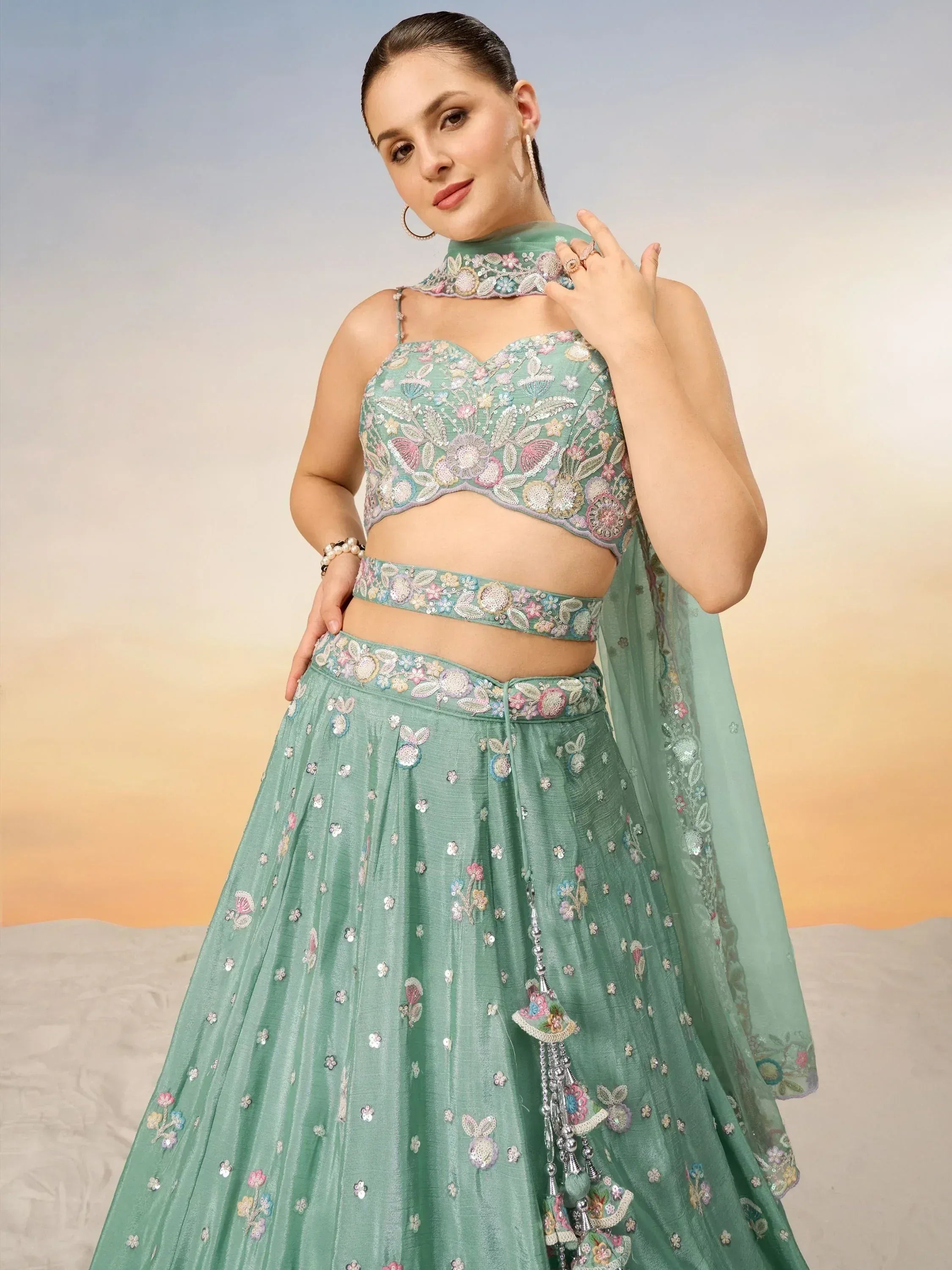Mint green embroidered lehenga choli with floral motifs, perfect for Indian ethnic wear and festive occasions.