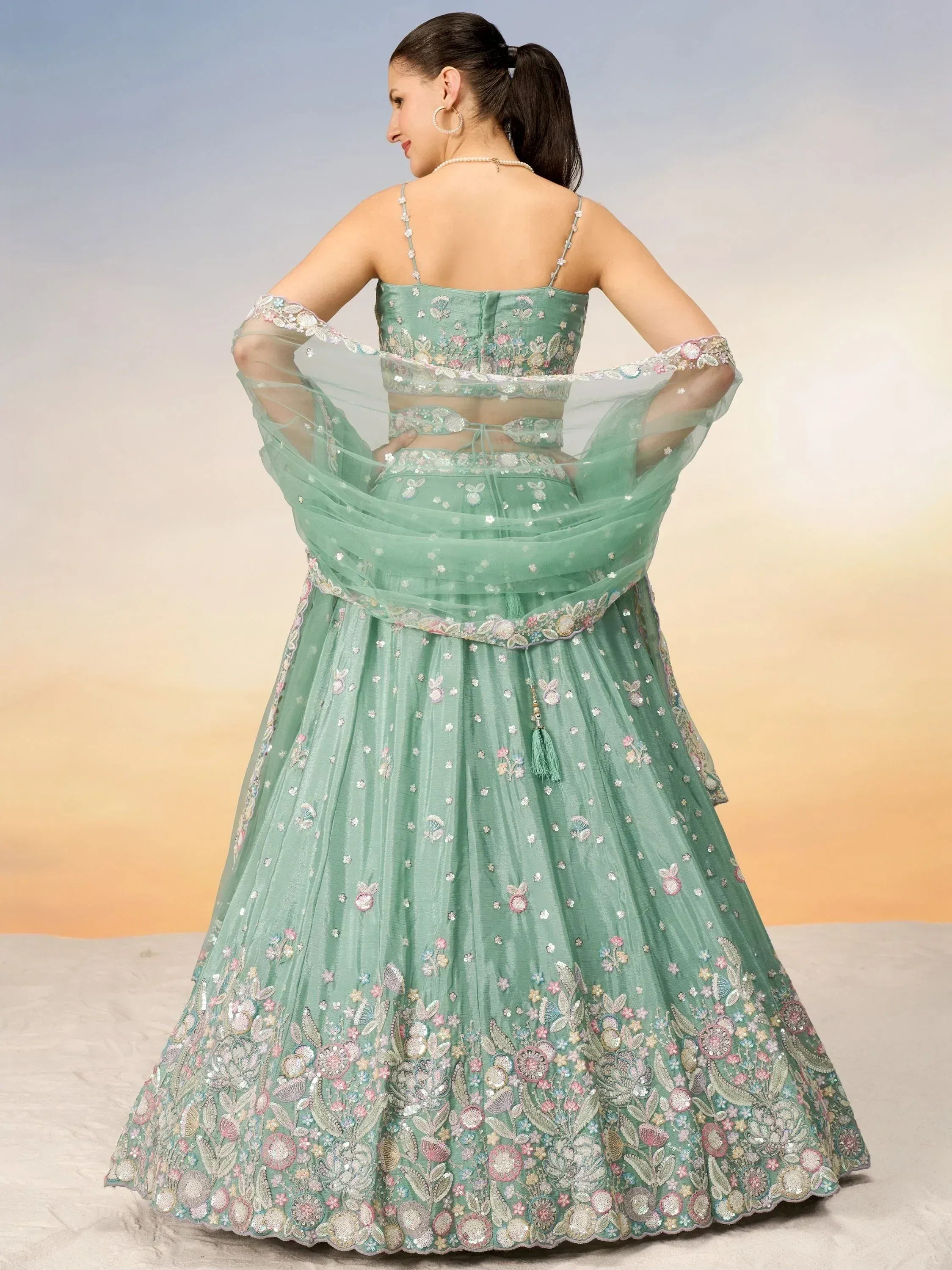 Mint green designer lehenga choli with floral embroidery and sheer dupatta, perfect for Indian ethnic wear.