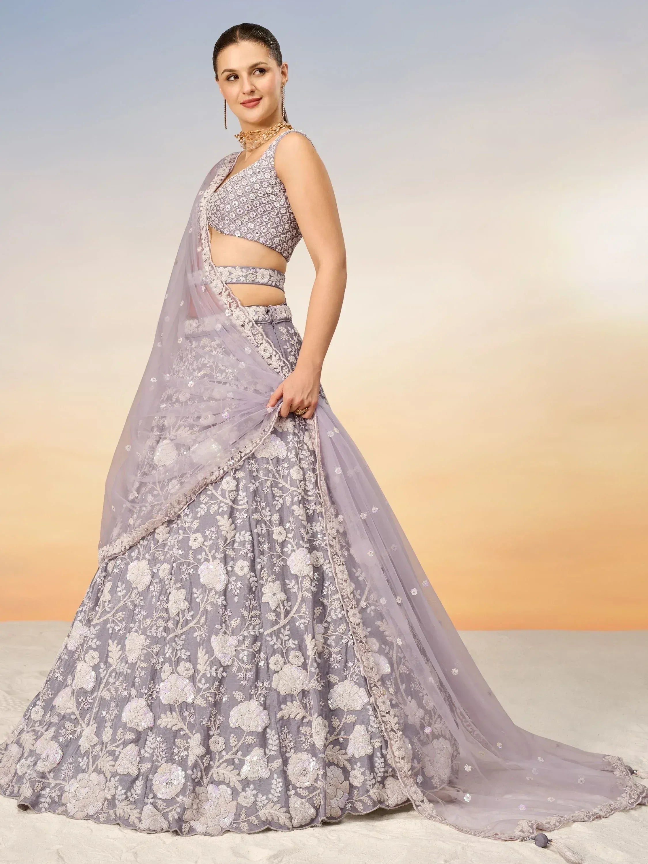 Lavender designer lehenga choli with floral embroidery and sheer dupatta, perfect for Indian weddings and festive occasions.