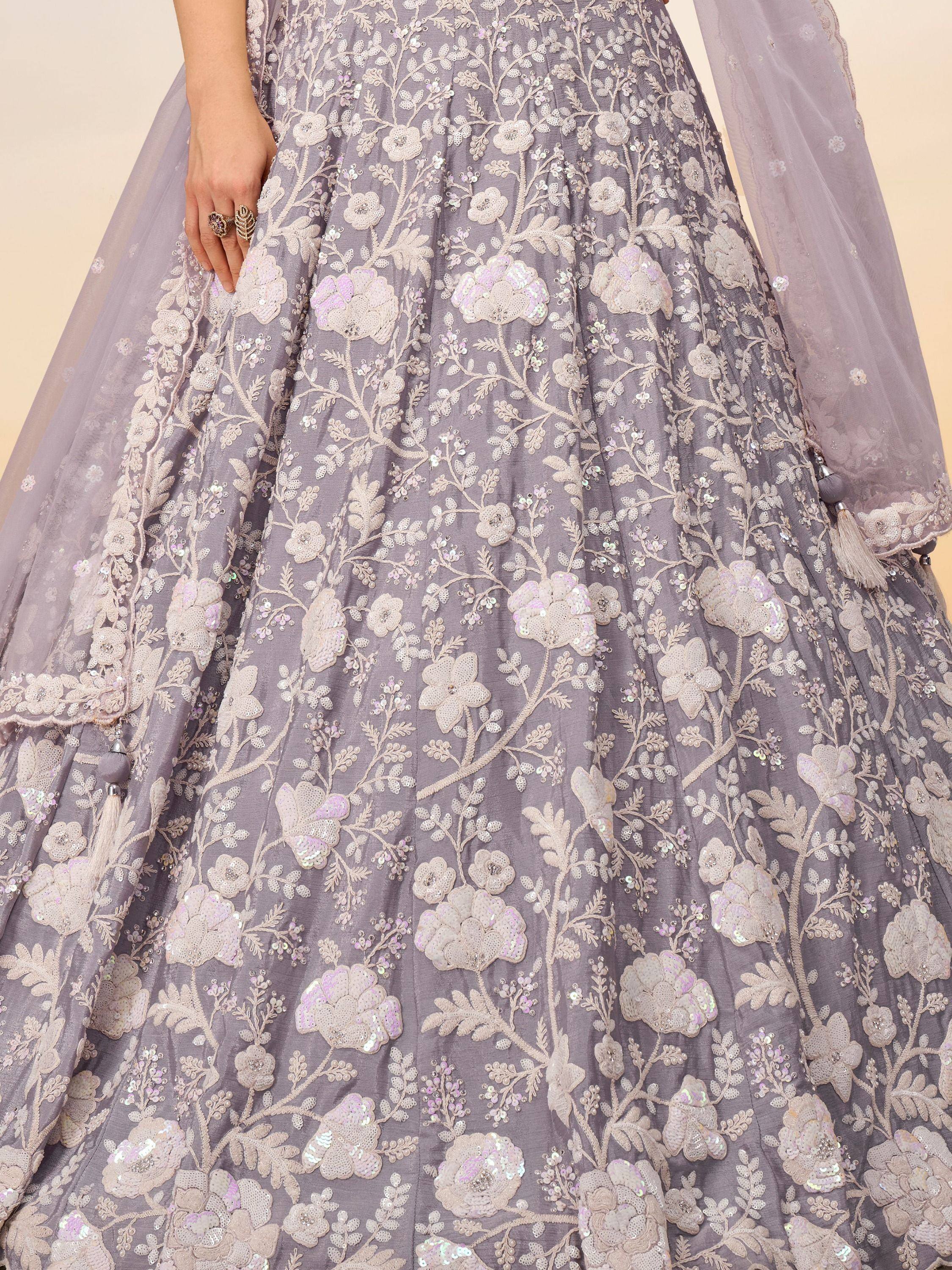 Grey floral embroidered lehenga with sequin detailing and tassel accents, perfect for Indian ethnic wear