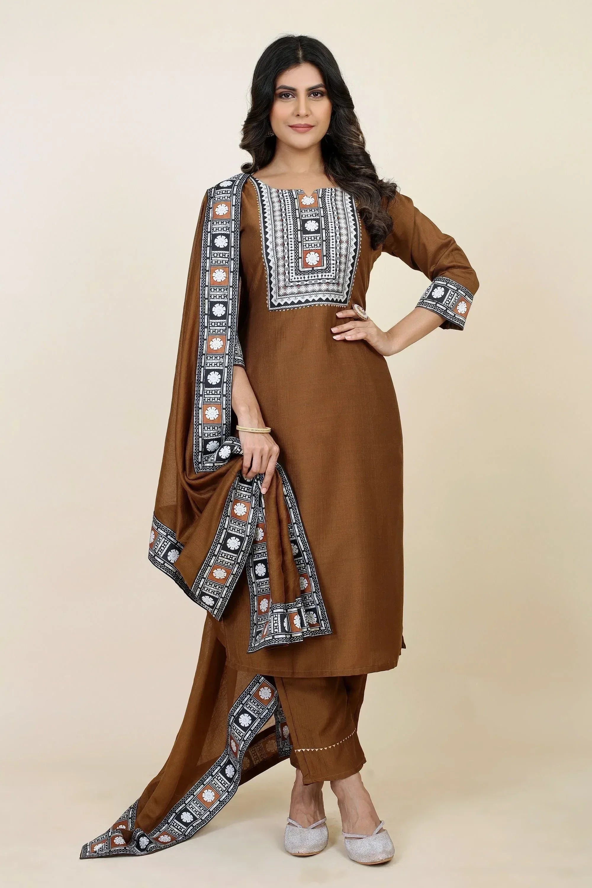 Brown ethnic kurta with printed dupatta, matching palazzo pants, and silver flats for women's traditional wear.