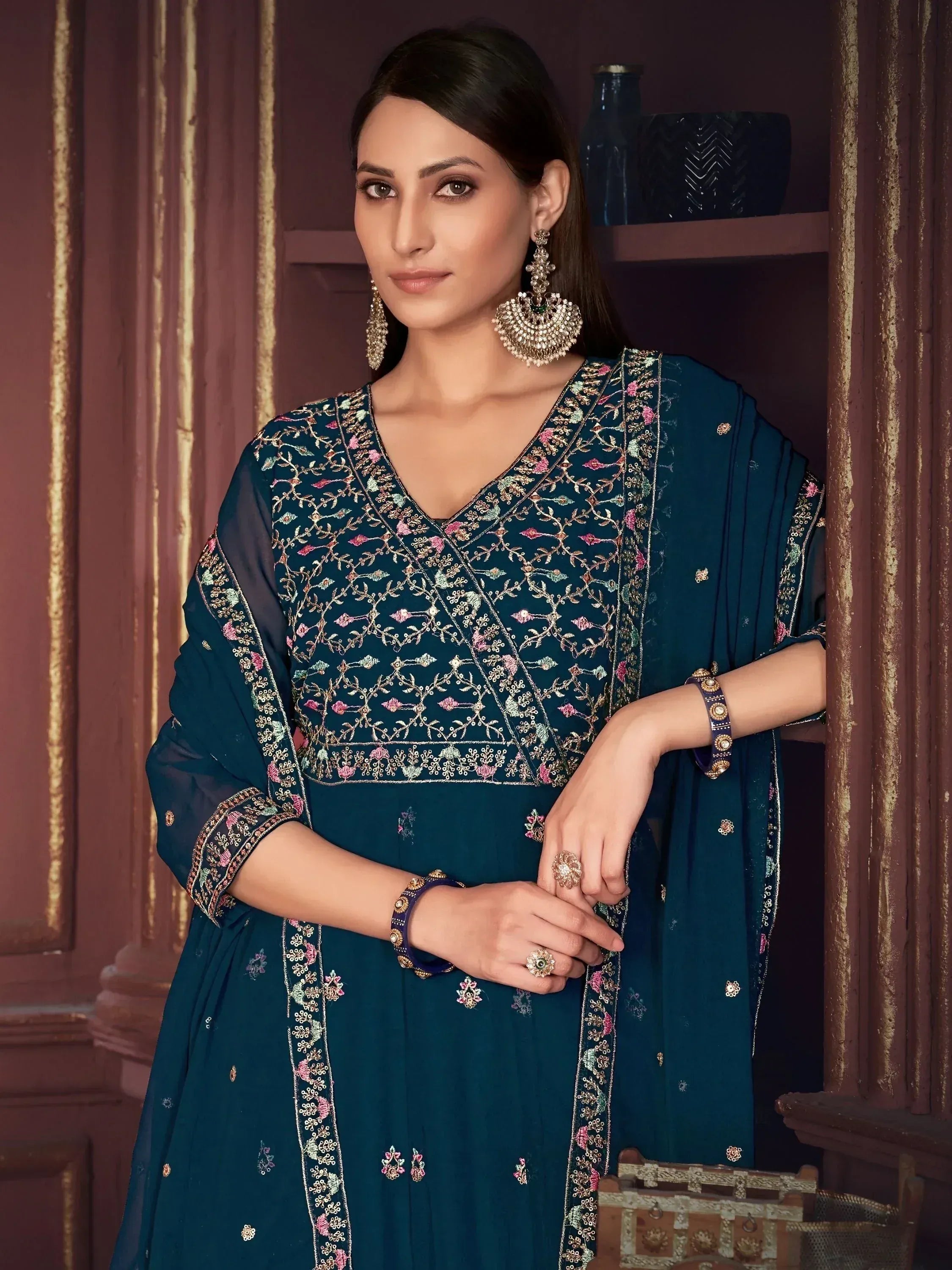 Elegant teal embroidered salwar kameez with floral motifs, perfect for Indian ethnic wear occasions.