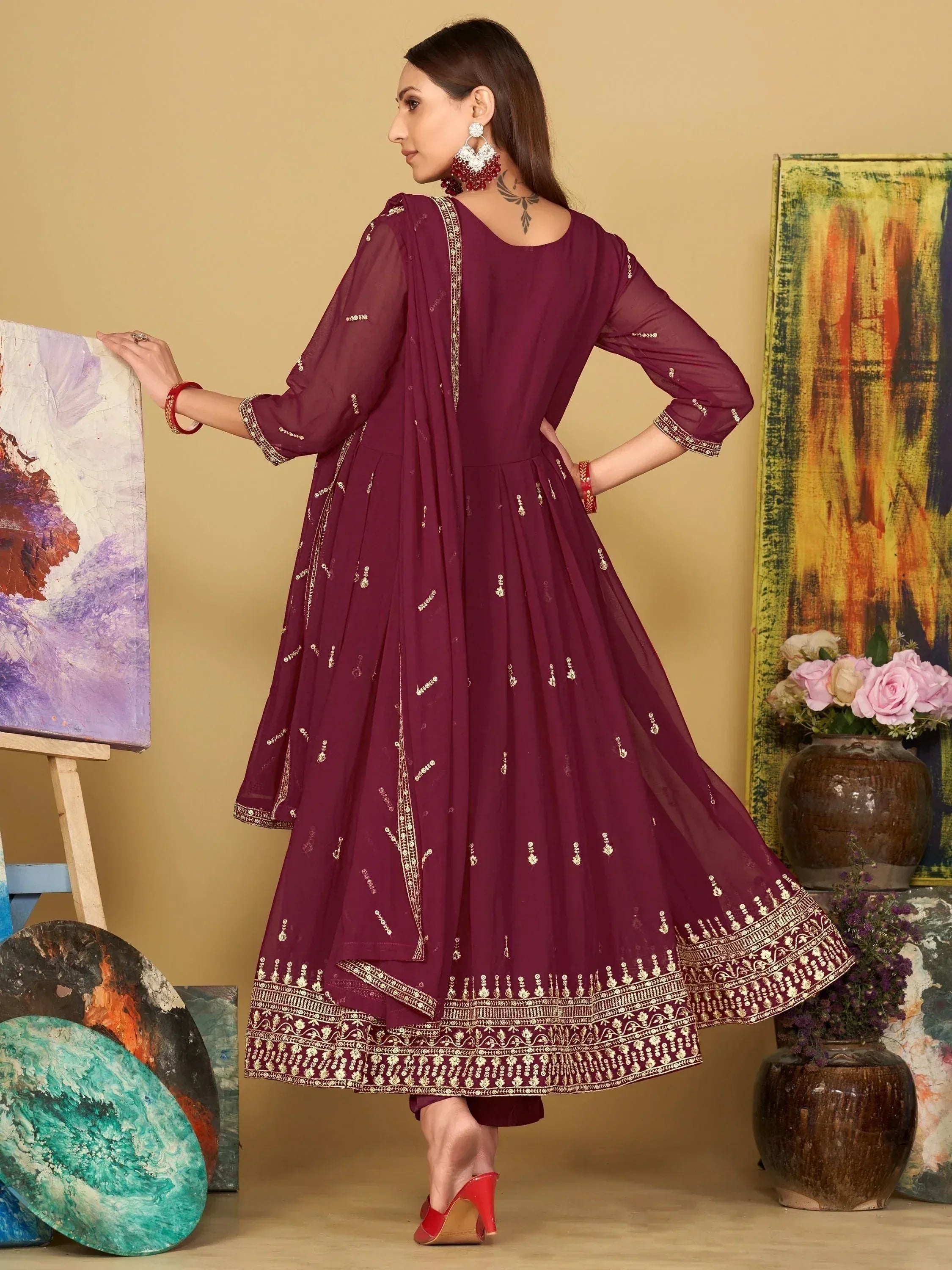 Elegant maroon ethnic gown with gold embroidery, perfect for Indian festive occasions