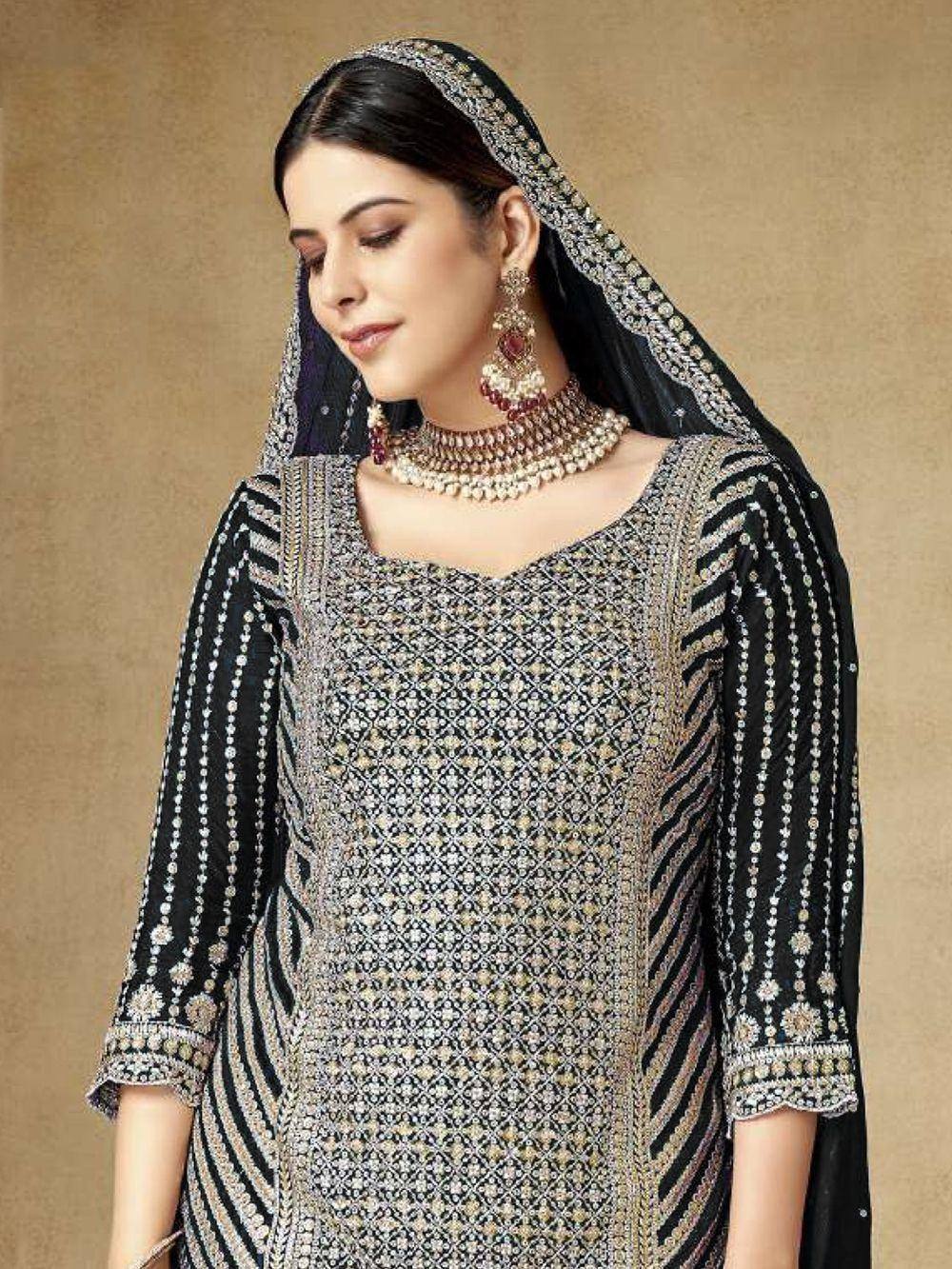 Elegant black and gold embroidered salwar kameez with matching dupatta and traditional jewelry