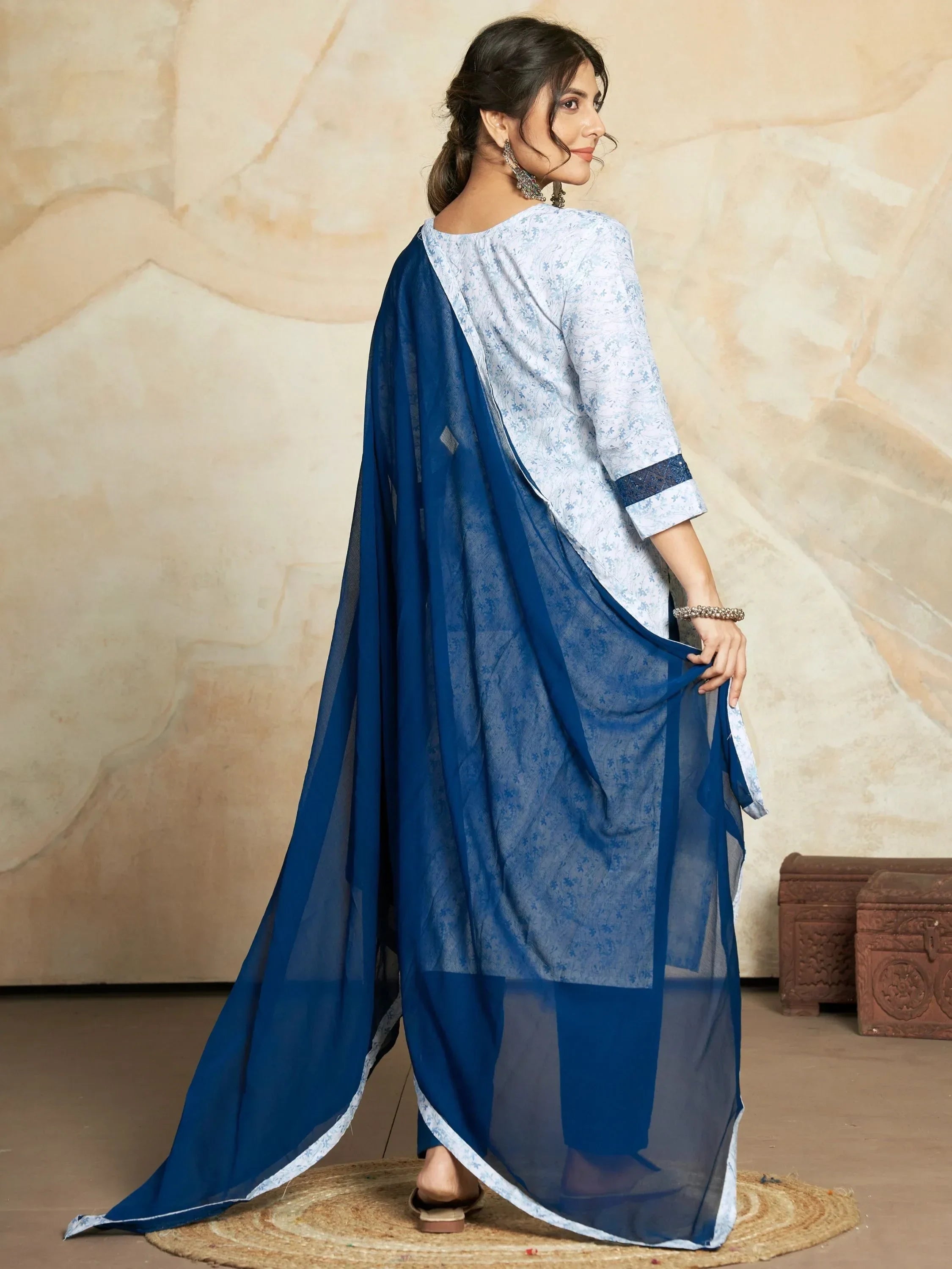 Woman in light blue floral salwar kameez with sheer navy dupatta, traditional Indian attire