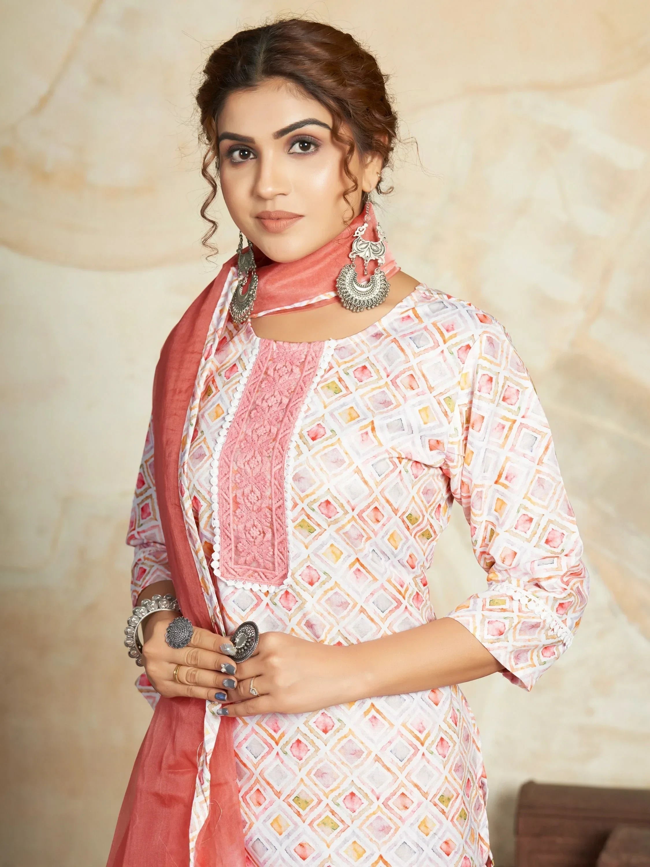 Woman in printed ethnic salwar kameez with dupatta and statement earrings