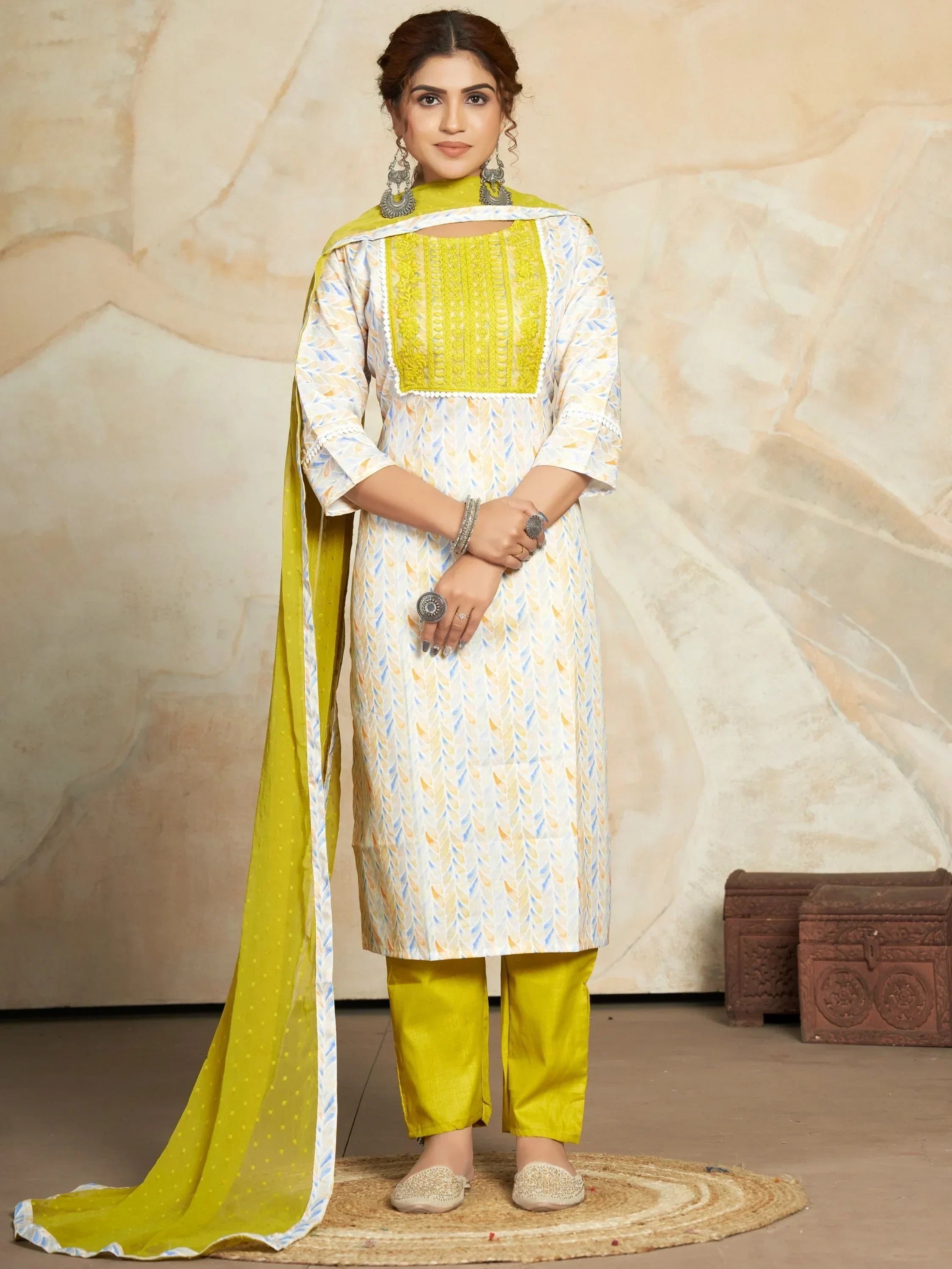 Woman wearing yellow embroidered salwar kameez with dupatta and statement jewelry