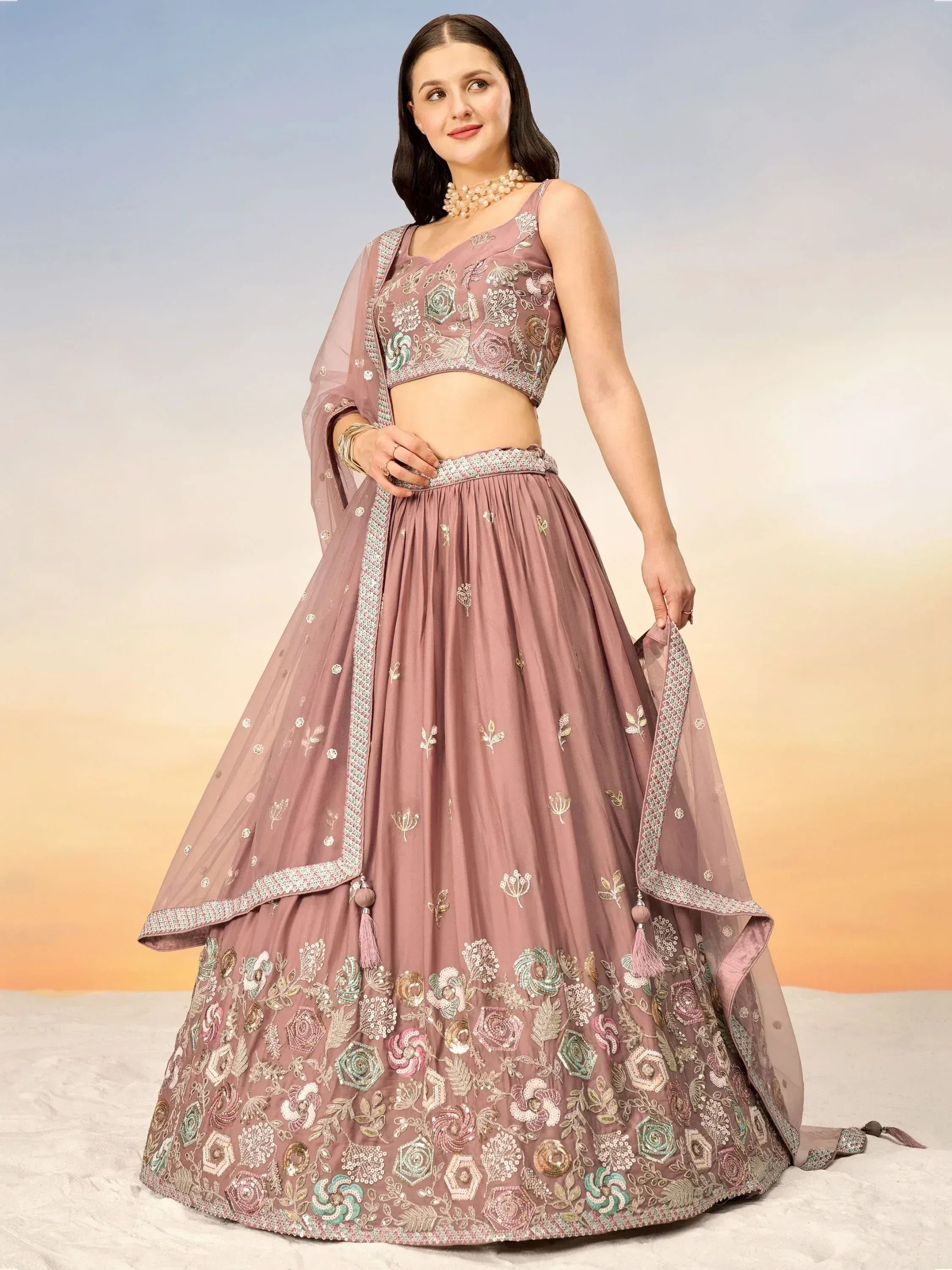 Elegant mauve lehenga choli with floral embroidery and tassels, perfect for Indian ethnic wear