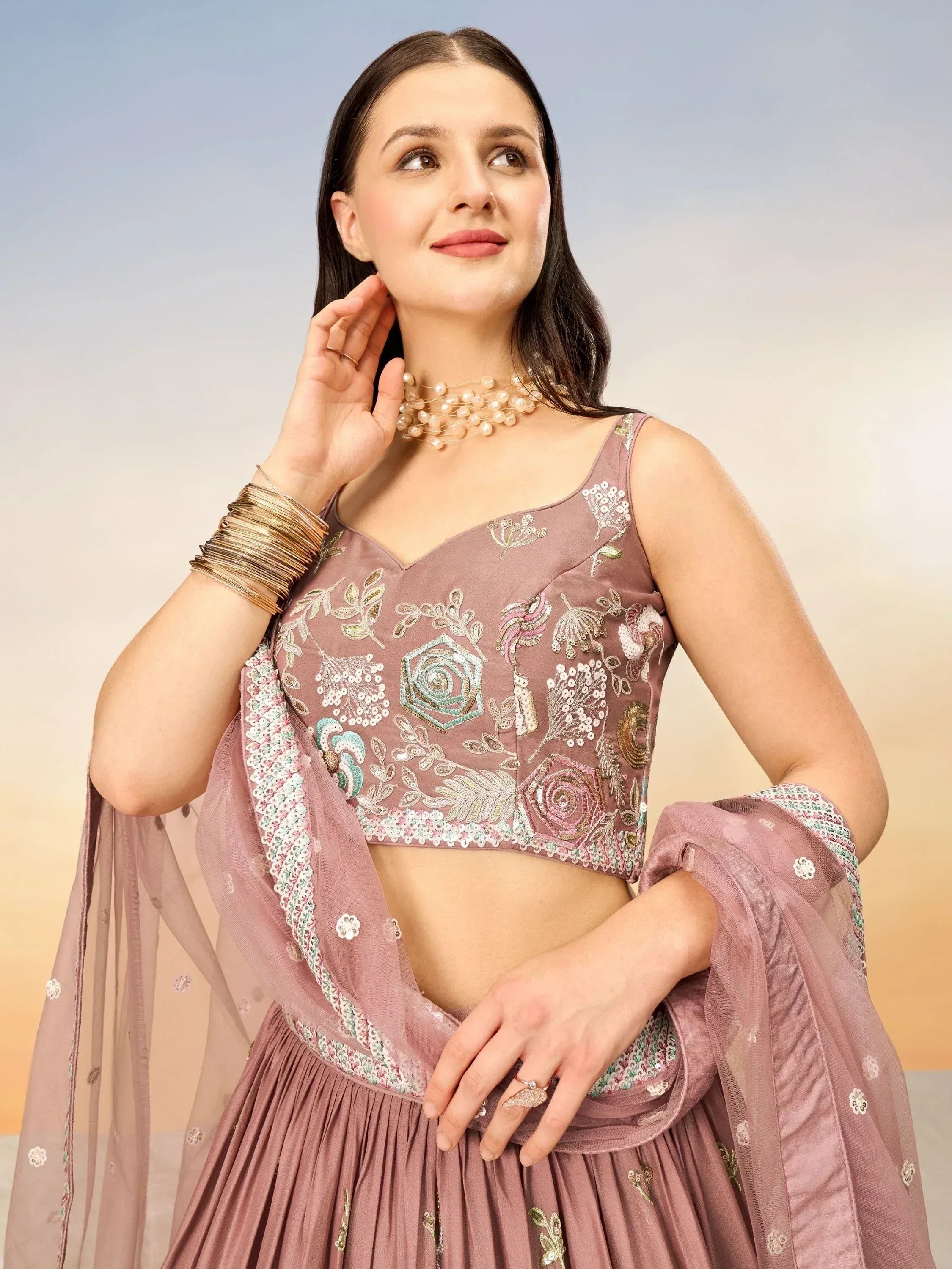 Elegant mauve lehenga choli with floral embroidery and sheer dupatta, perfect for Indian ethnic wear.