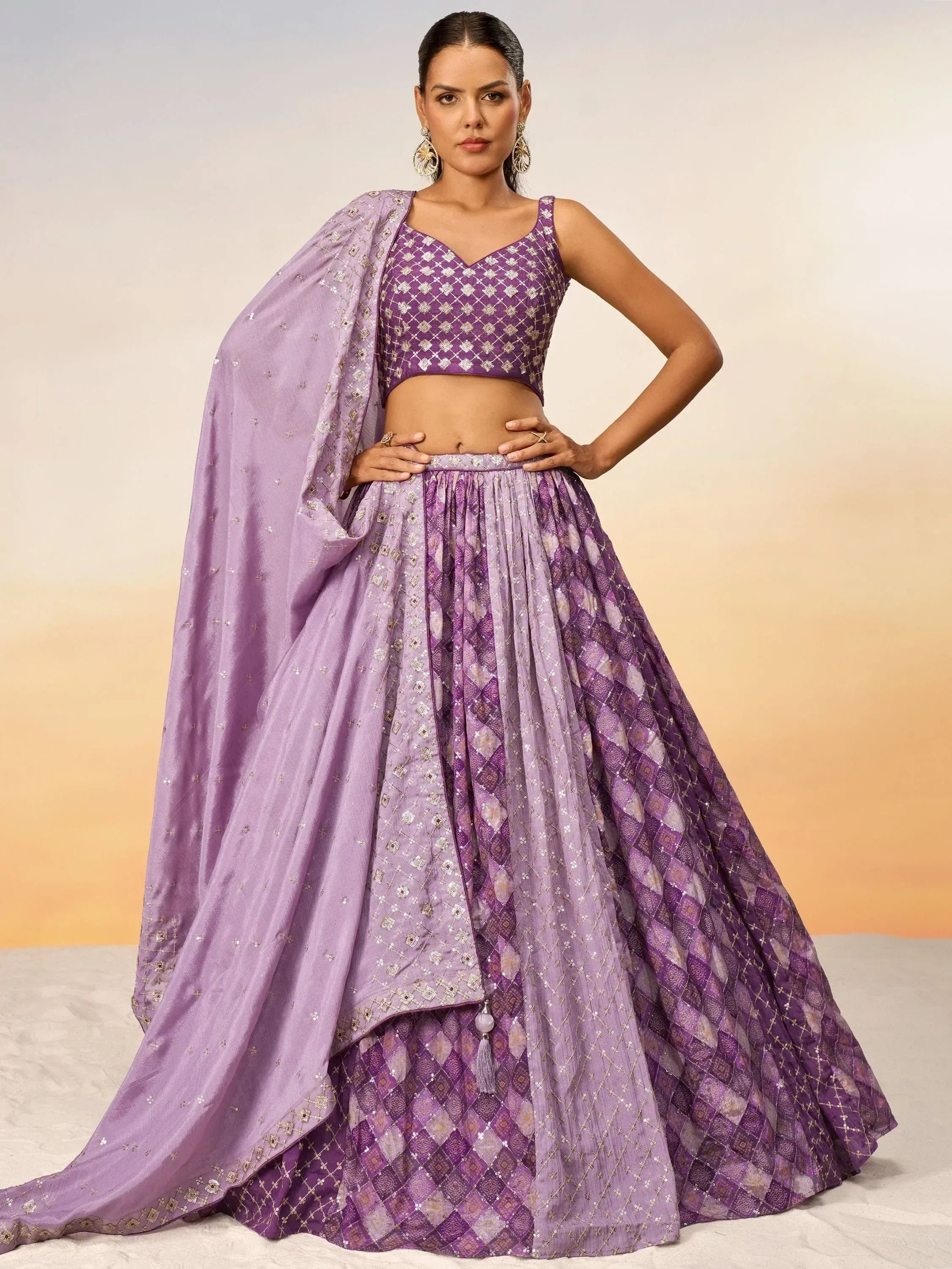 Purple designer lehenga choli with intricate embroidery and matching dupatta, perfect for Indian ethnic occasions.