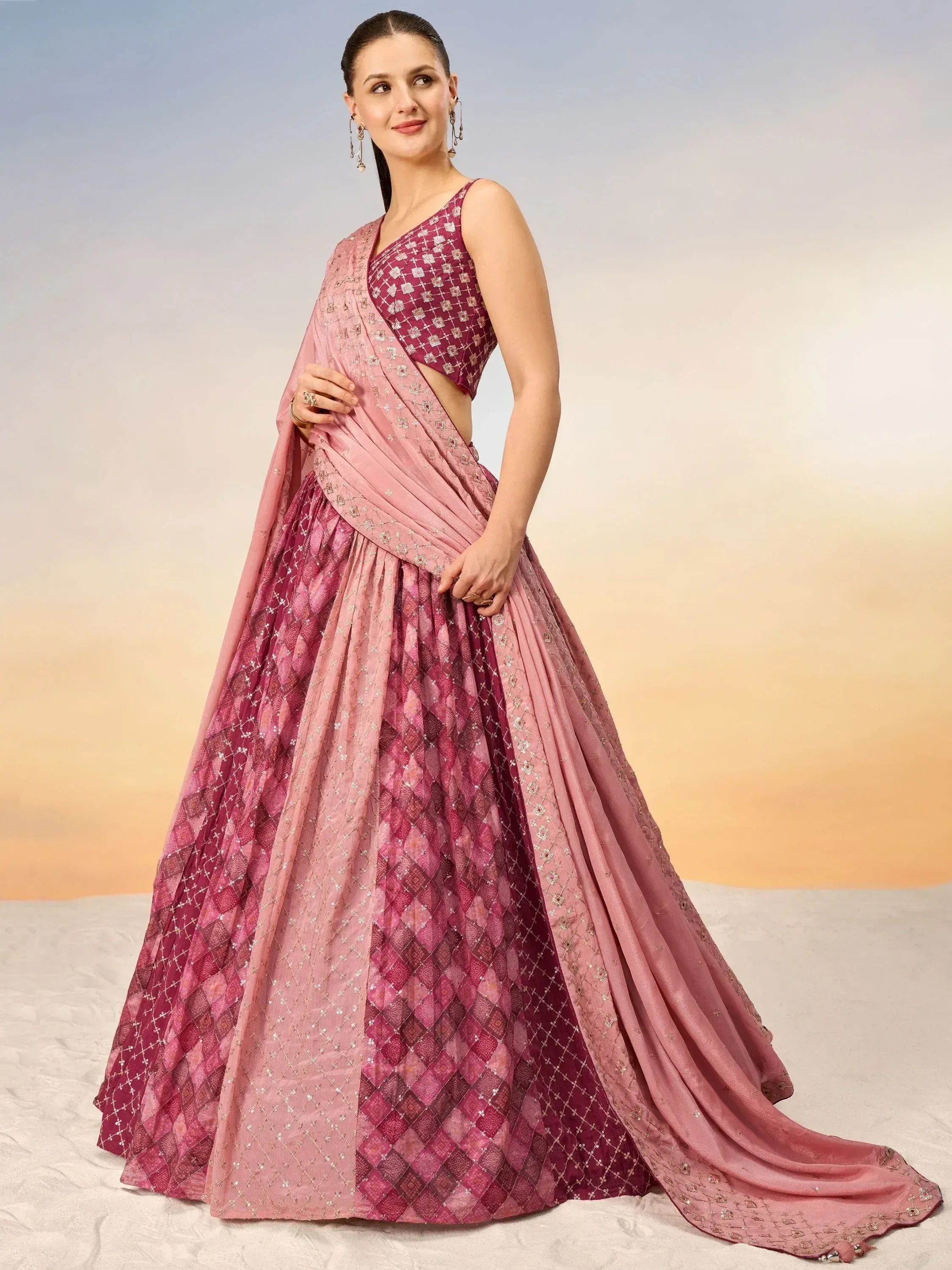 Elegant pink and maroon designer lehenga choli with intricate embroidery and flowing dupatta