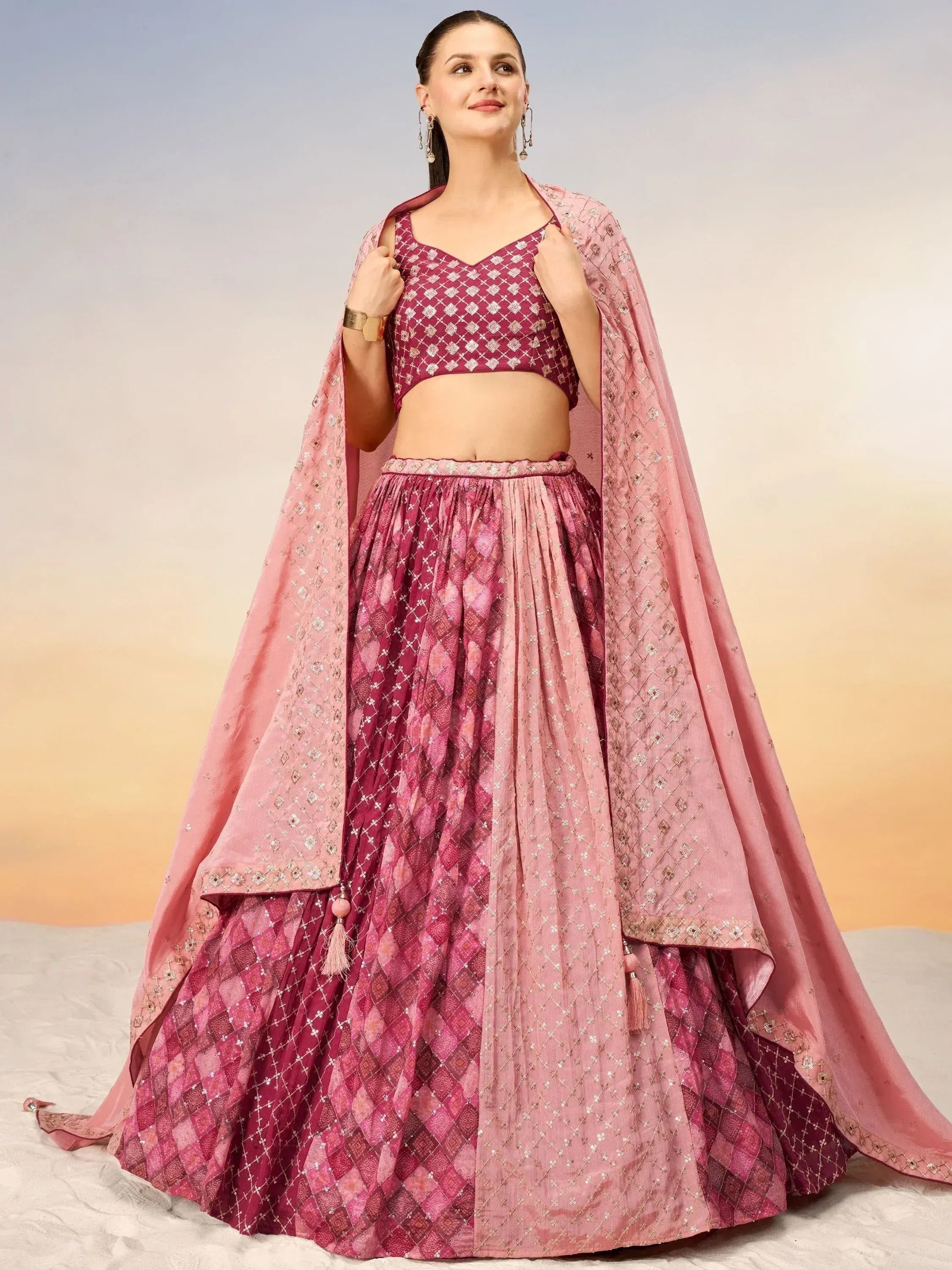 Elegant pink and maroon lehenga choli with intricate embroidery and dupatta for Indian ethnic wear