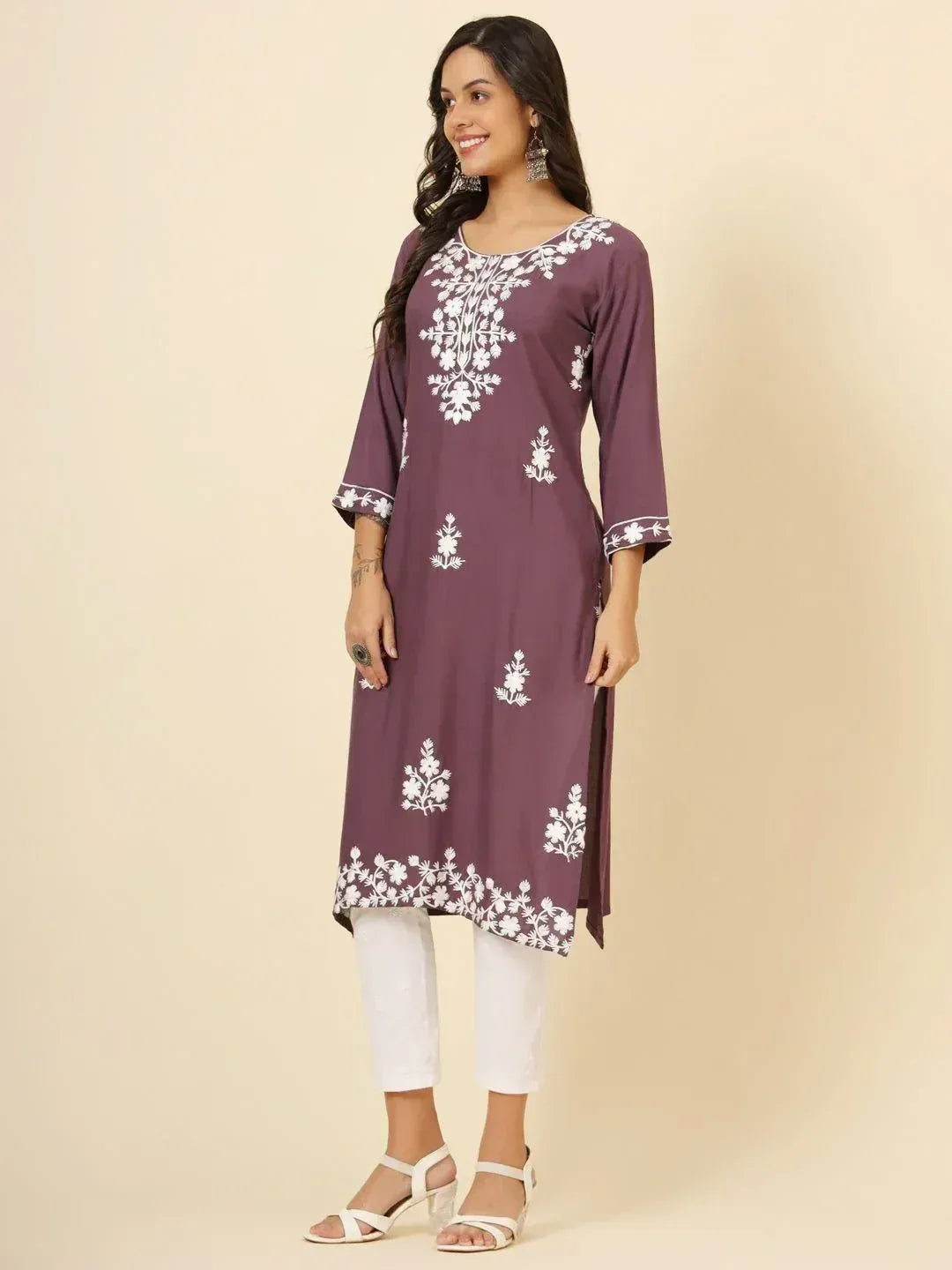 Purple ethnic kurti with white floral embroidery, paired with white pants for casual wear