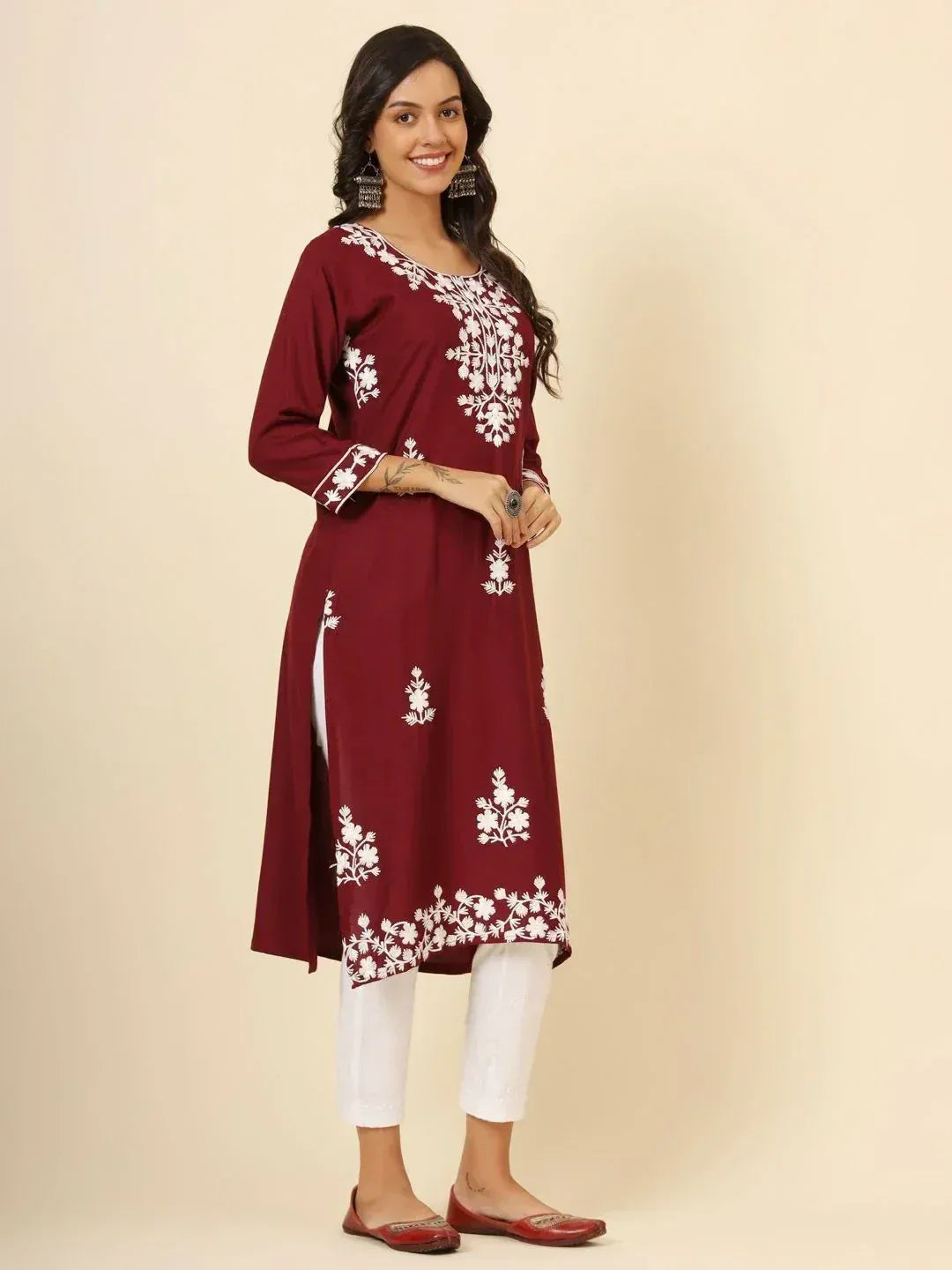 Maroon embroidered kurta with white floral design, paired with white pants for ethnic wear