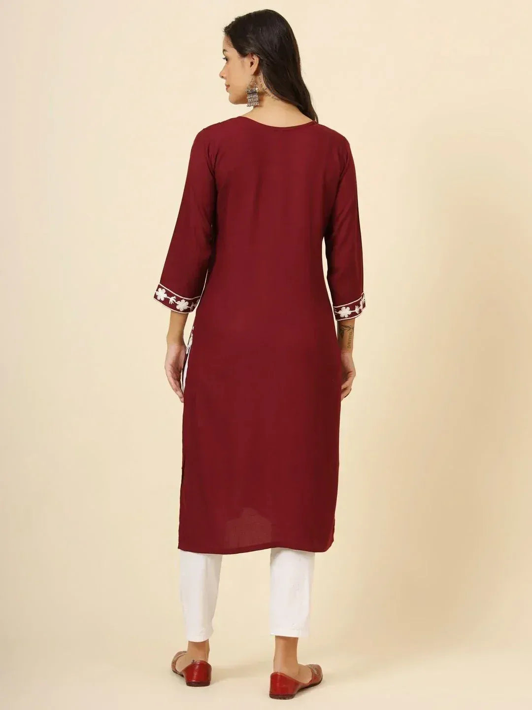 Maroon ethnic kurti with white floral embroidery on sleeves, paired with white pants for women