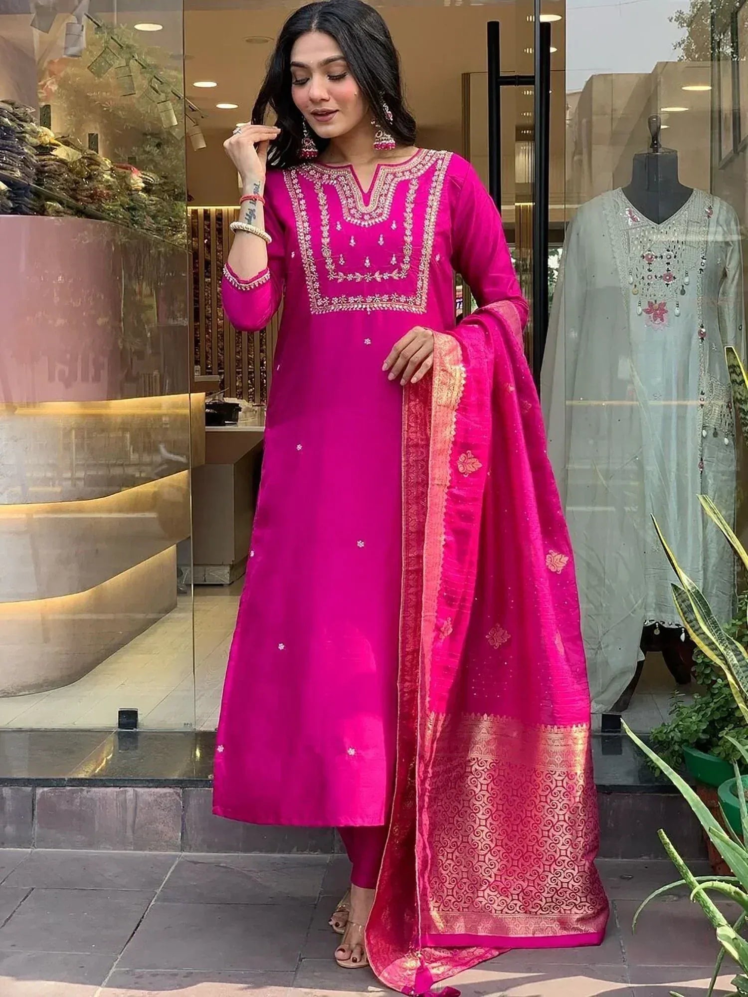 Vibrant pink embroidered ethnic kurti with golden dupatta, perfect for festive occasions