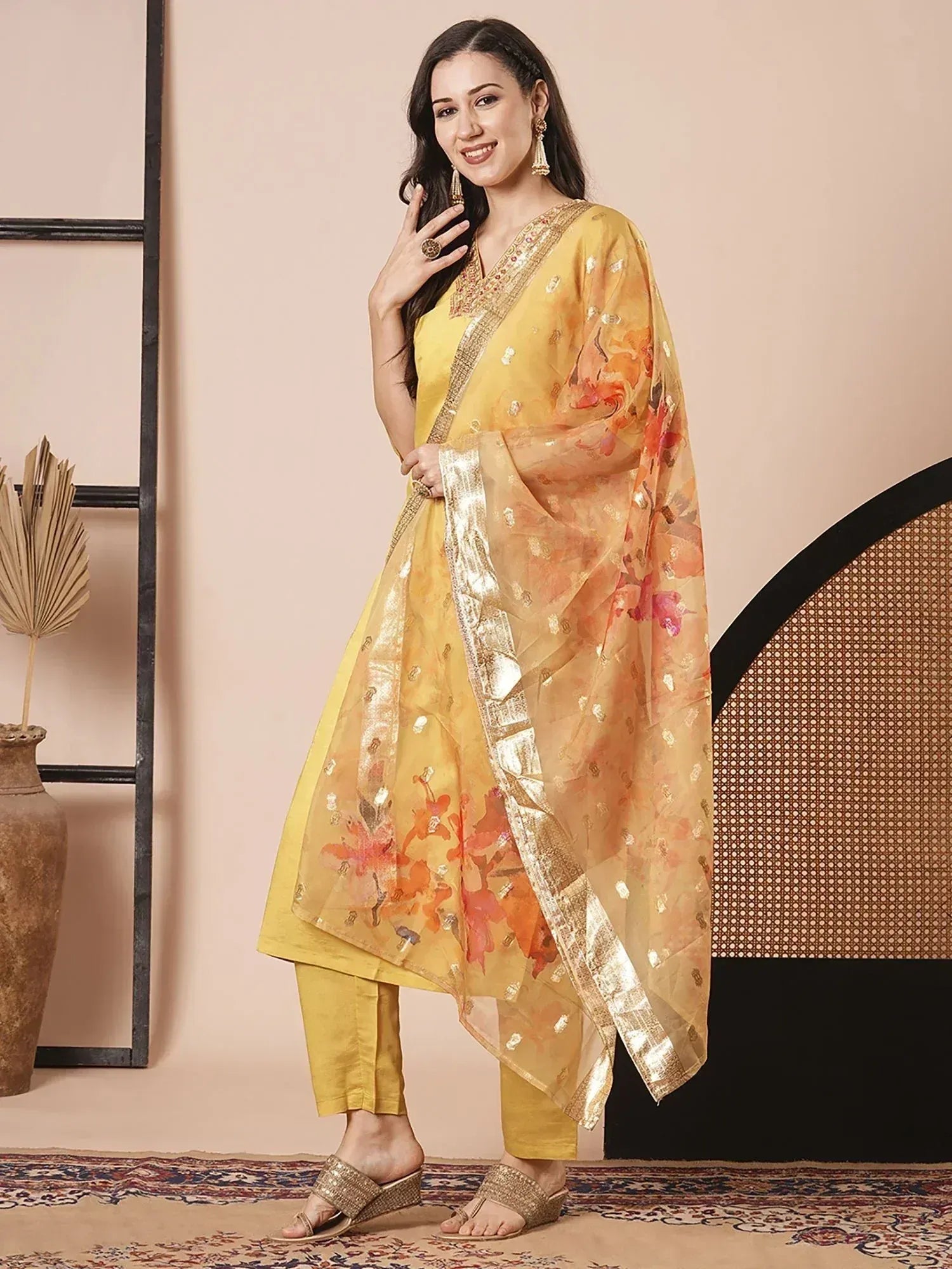 Yellow floral printed salwar kameez with gold embroidery, perfect for ethnic wear occasions