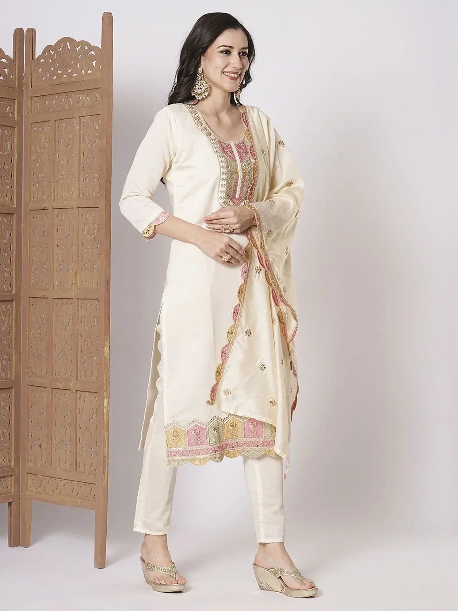 Cream embroidered salwar kameez with pink gold detailing, perfect for Indian ethnic wear occasions.