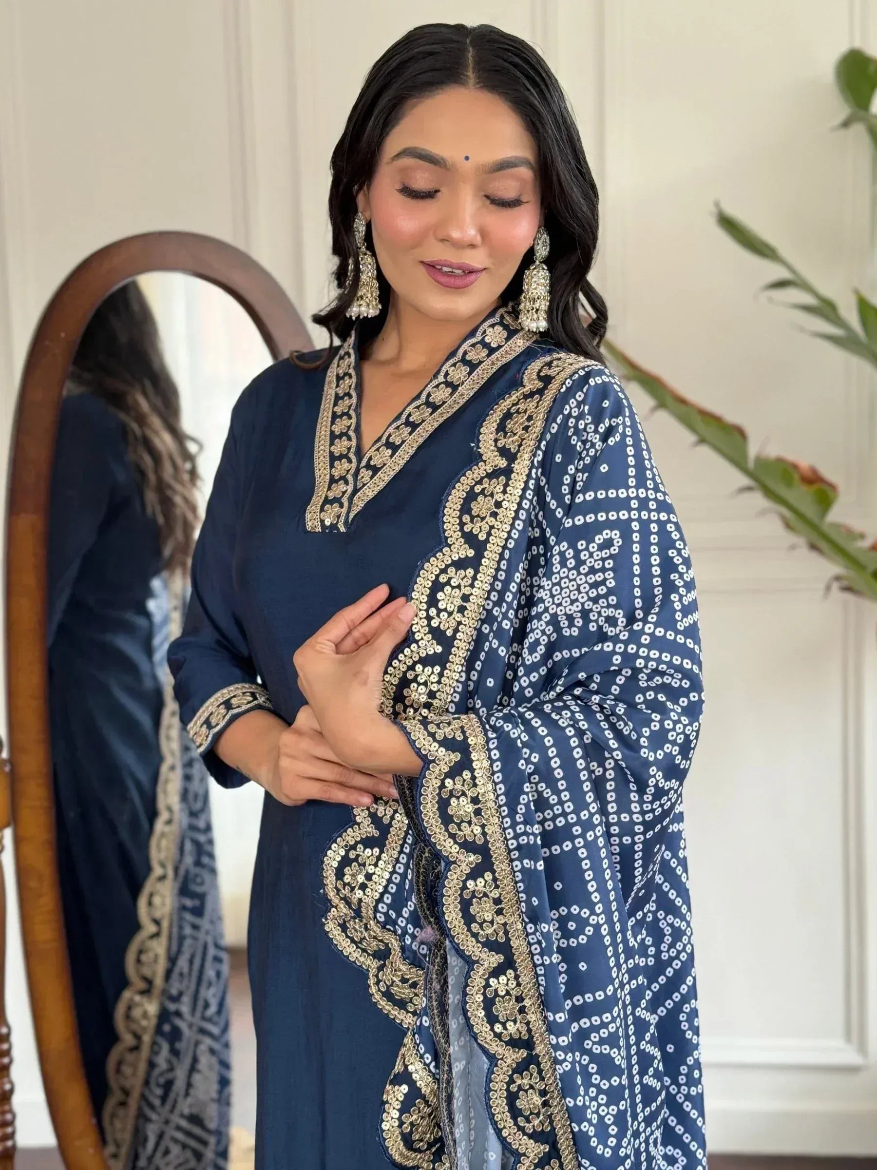 Navy blue ethnic kurti with gold embroidery and printed dupatta, styled with statement earrings