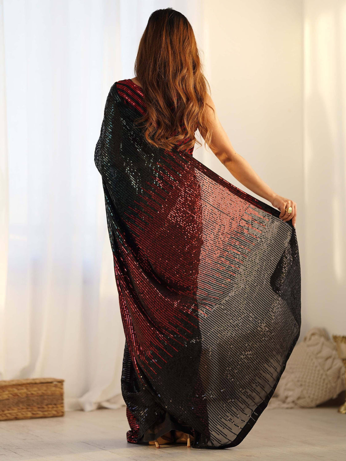 Woman in black and red sequin saree, showcasing elegant ethnic wear for festive occasions