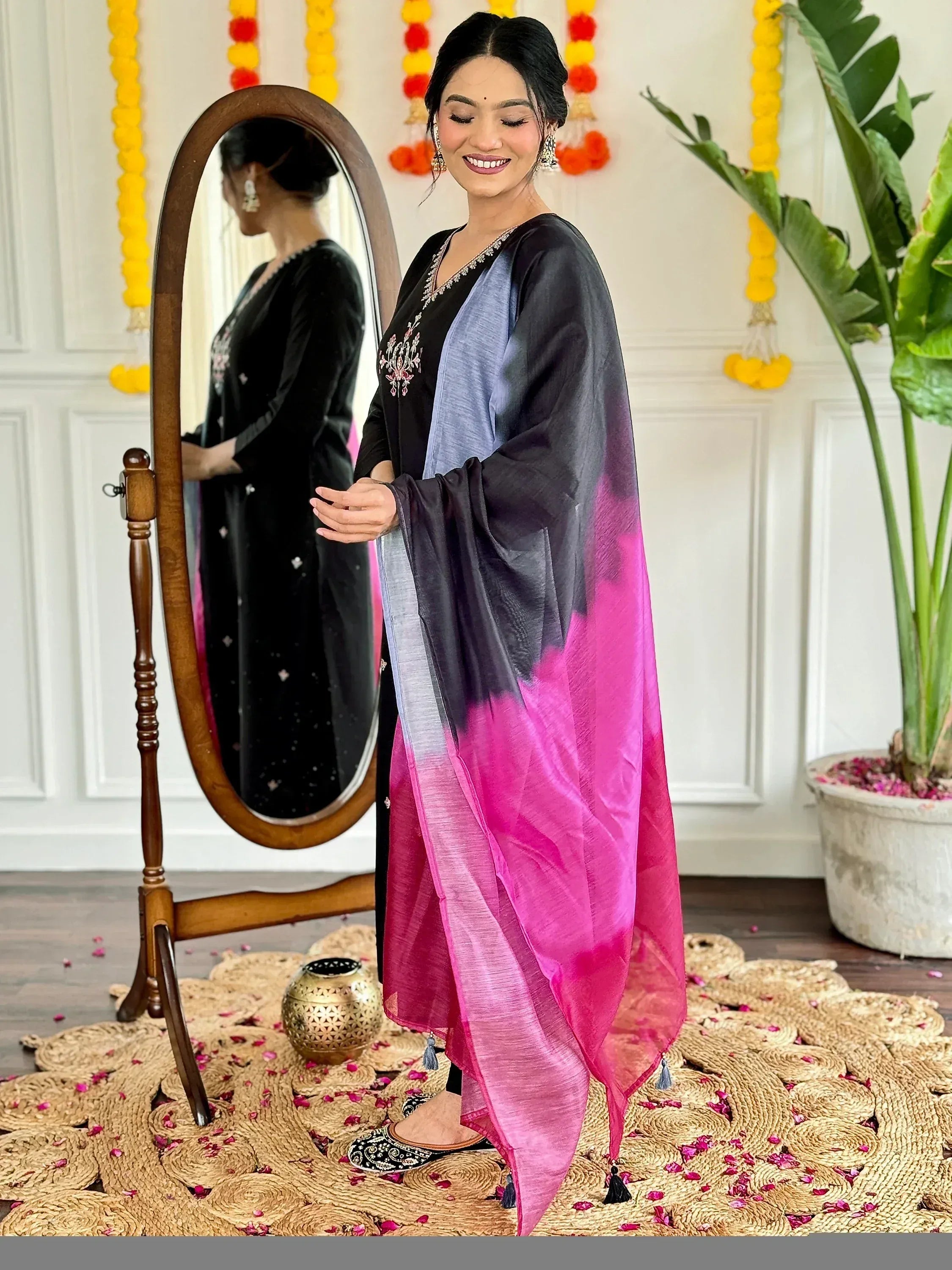 Woman in black embroidered kurta with gradient dupatta, festive Indian ethnic wear