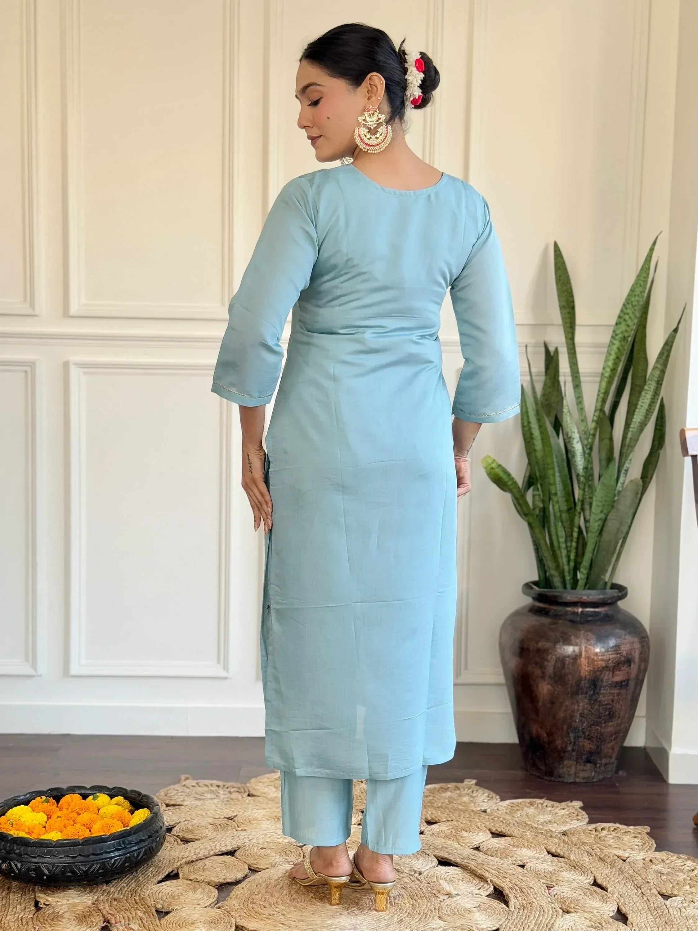 Light blue ethnic kurta with matching pants, styled with gold heels and floral hair accessory