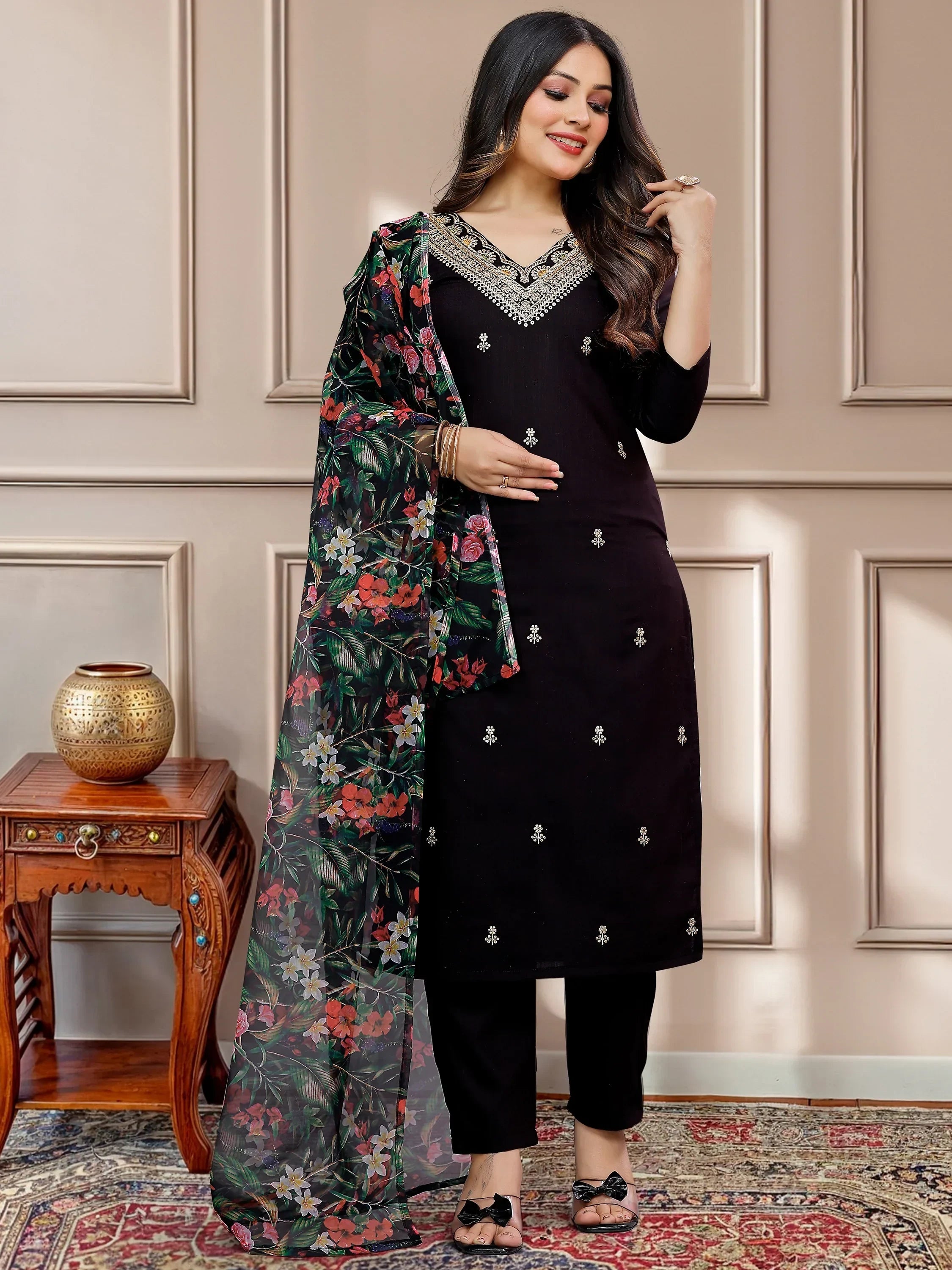 Woman wearing a black embroidered salwar kameez with floral printed dupatta, ethnic wear