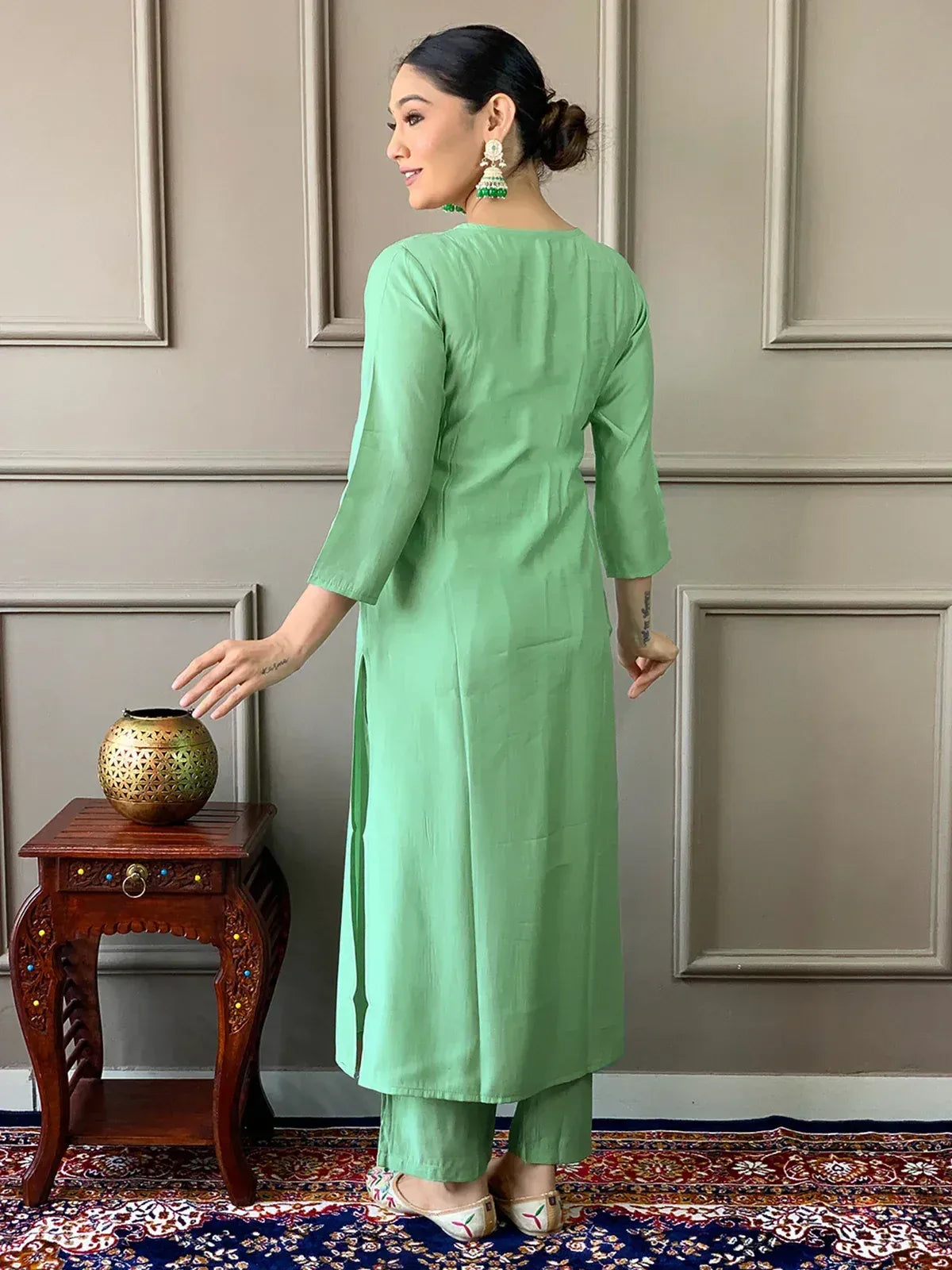 Mint green ethnic kurta with matching pants, styled with jhumka earrings and embroidered flats for traditional Indian wear.