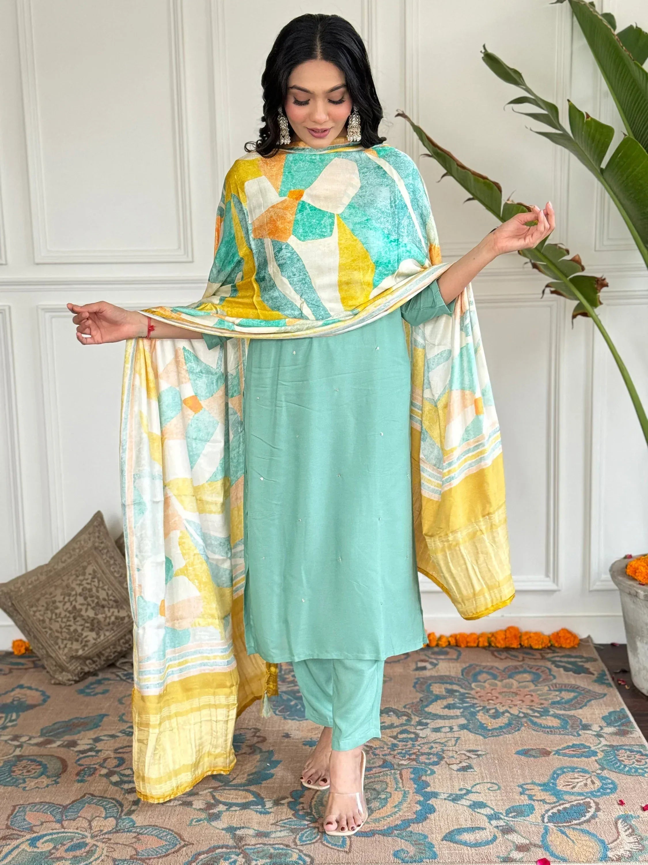 Woman in mint green salwar kameez with yellow and teal printed dupatta, ethnic Indian wear