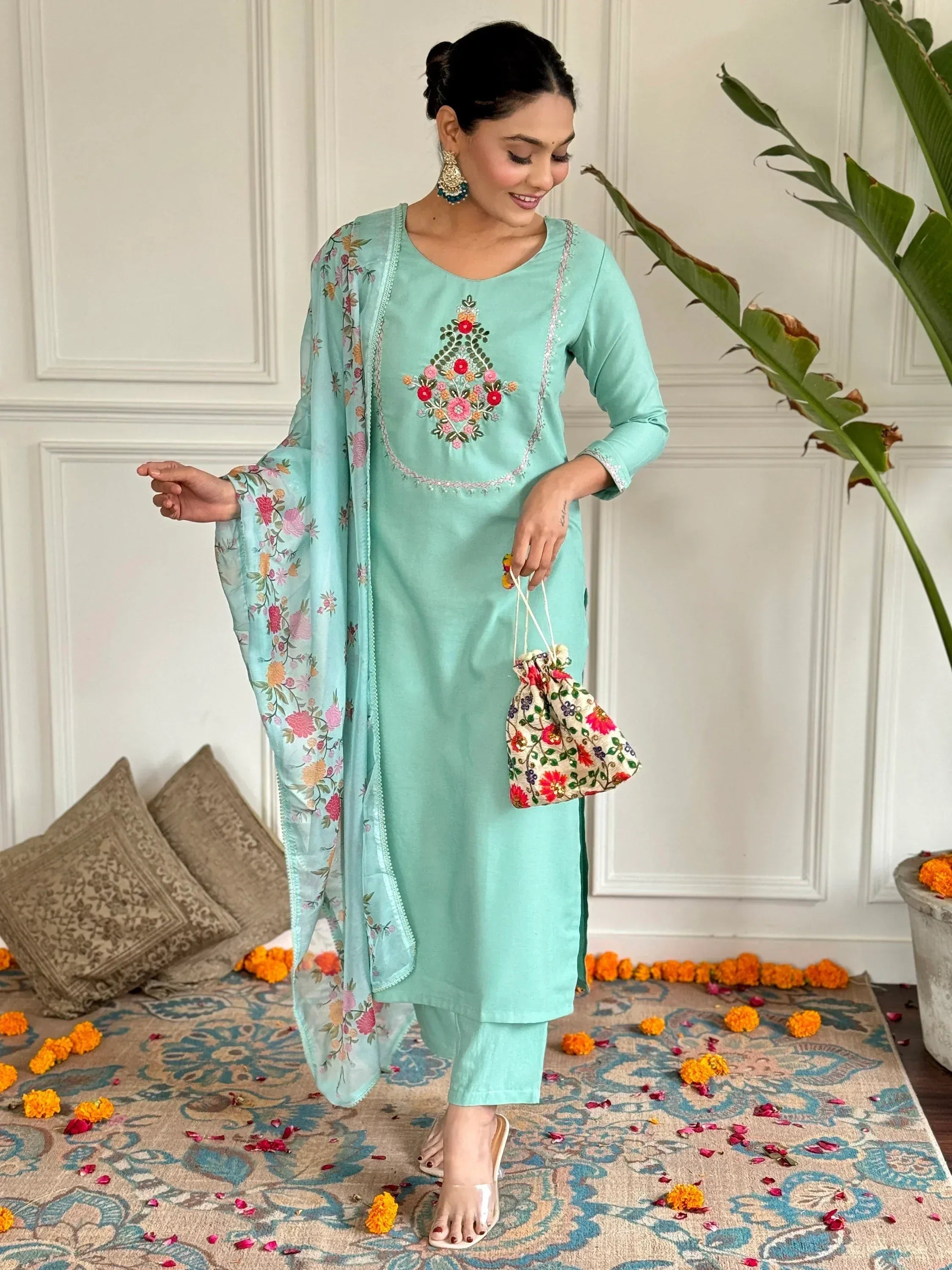 Mint green embroidered salwar kameez with floral dupatta and potli bag, perfect for Indian ethnic occasions