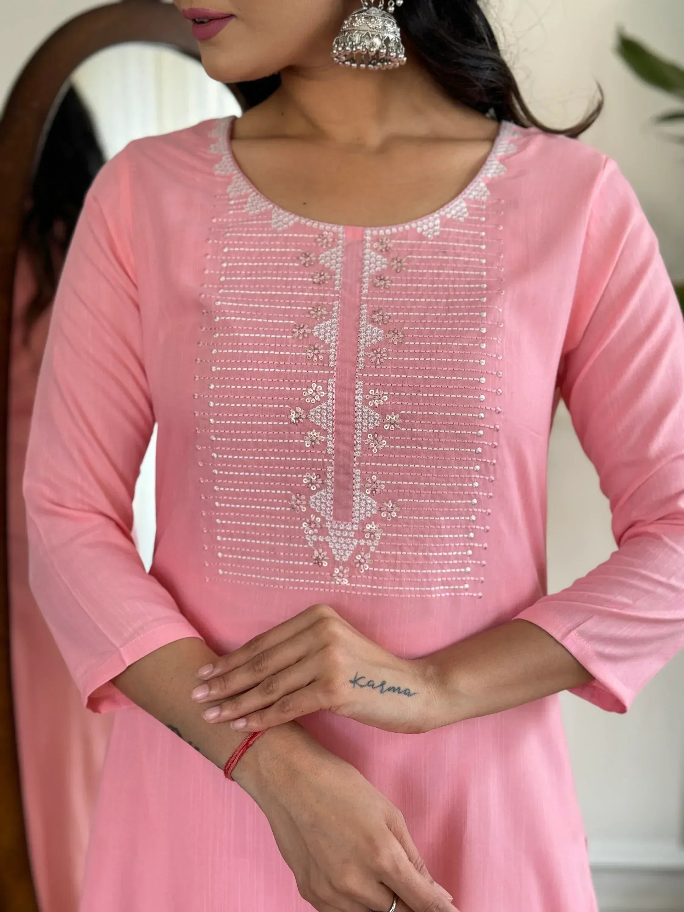 Pink embroidered kurta with floral detailing, paired with jhumka earrings for ethnic wear