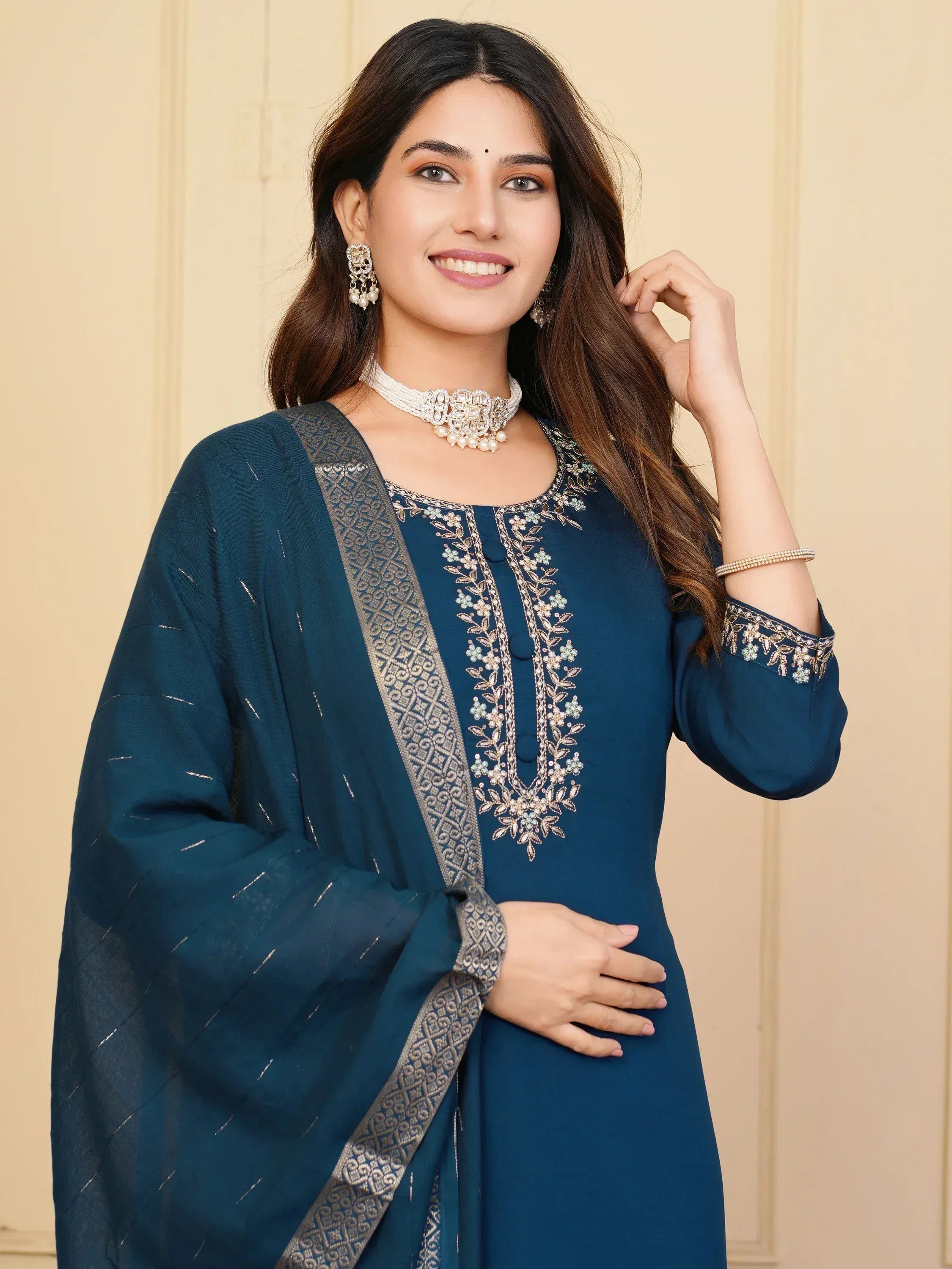 Woman in elegant teal embroidered salwar kameez with matching dupatta, perfect for Indian ethnic occasions